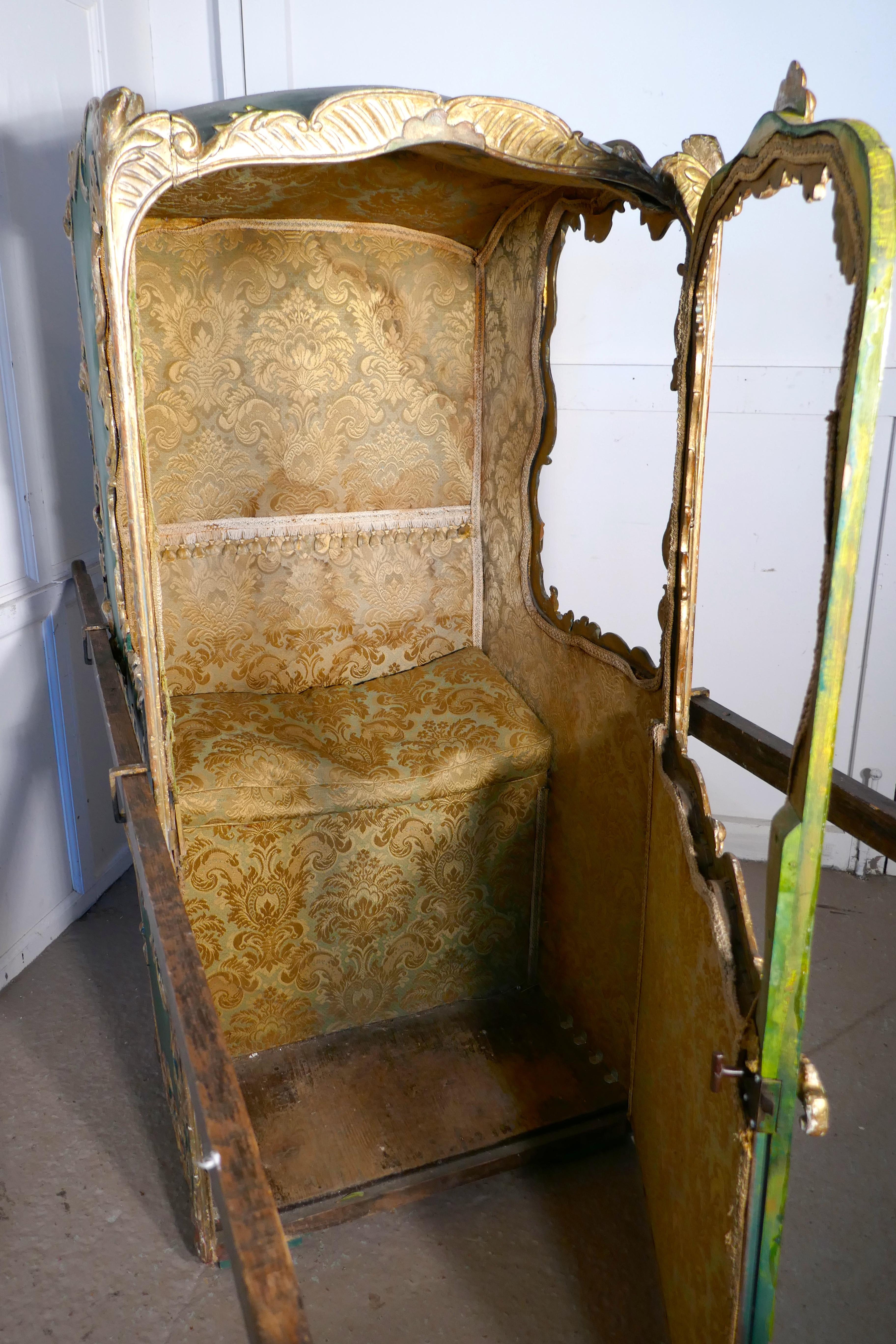 19th Century Italian Sedan Chair  

This is a mid 19th Century piece, it is the Rococo style, in Green and Gold and upholstered inside in a heavy gold brocade, complete with cushion on the seat
The chair has an outward opening door and side windows,