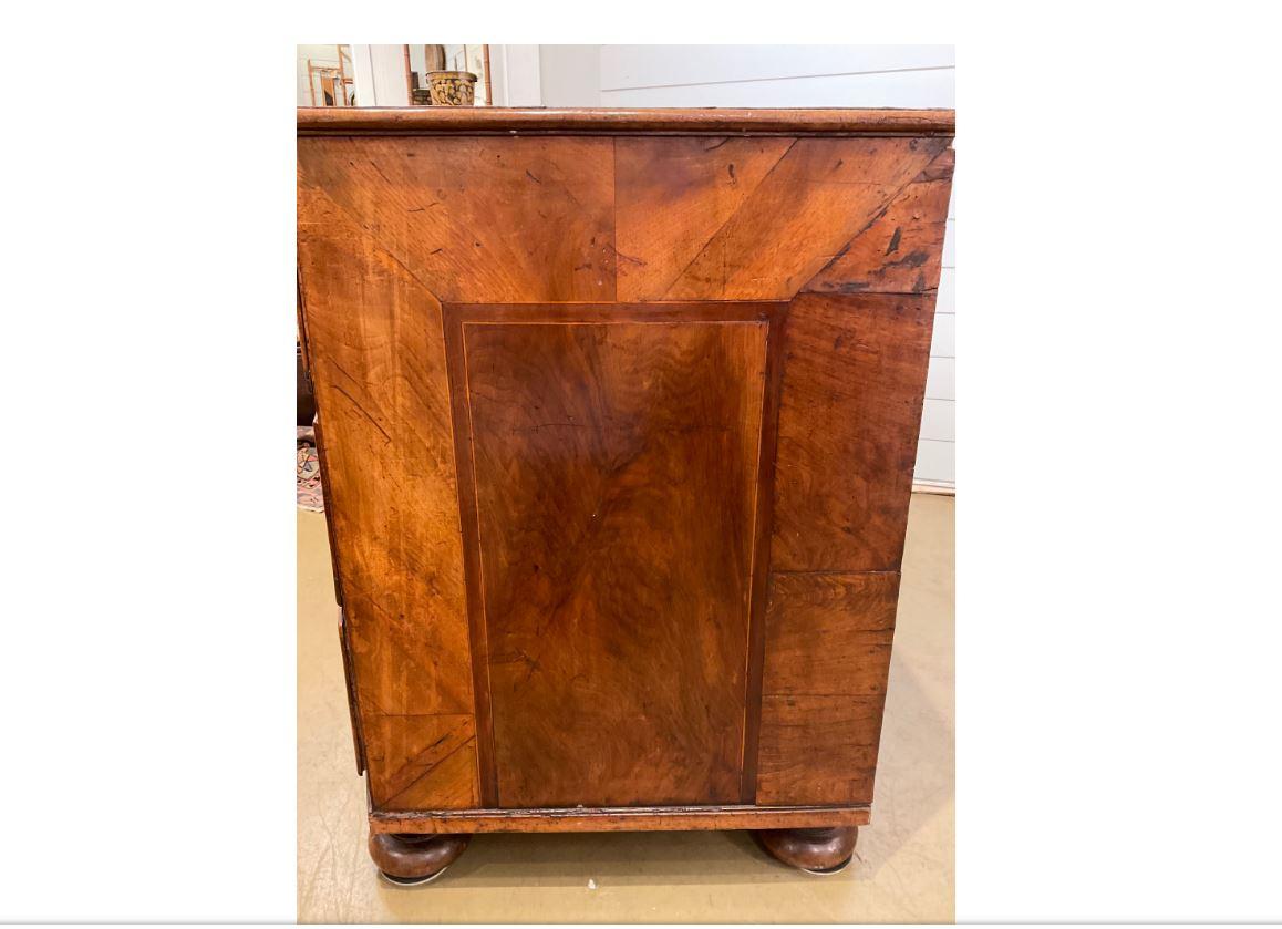 This is a stunning Italian antique piece! This chest of drawers is serpentine front, with beautiful, vivid, handmade inlay patterns on the front. The ornate brass pulls add even more magnificence to this chest. This piece would make a gorgeous