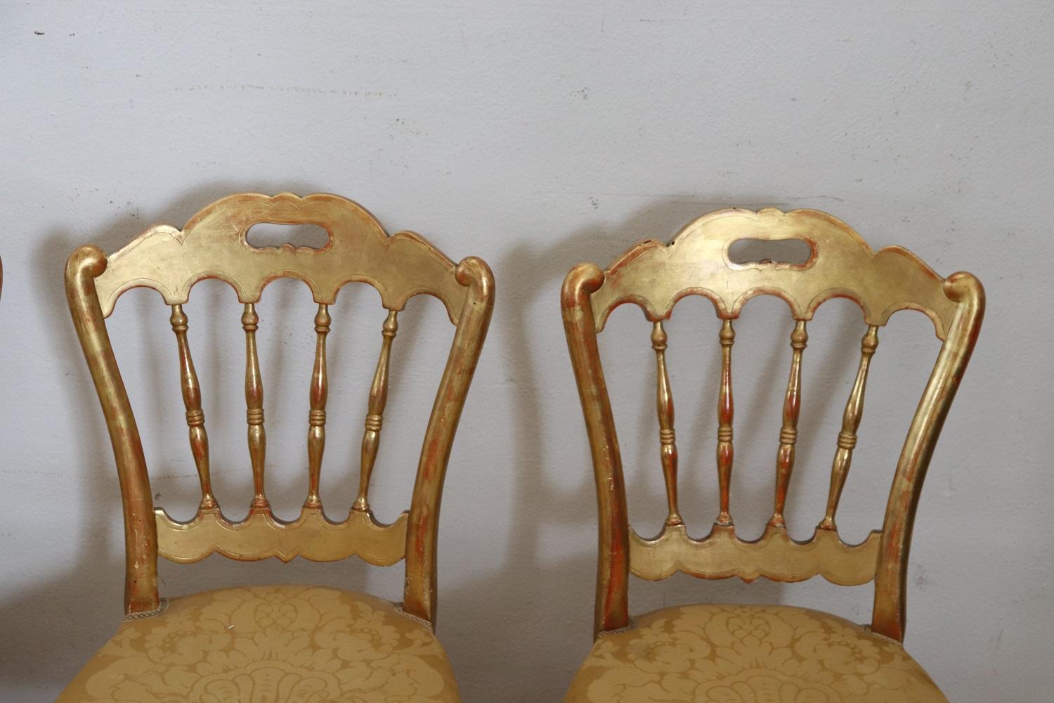 Very nice series of four chairs production of Chiavari Italy cabinetmakers laboratories. All the chairs you see on sale are antique 1880s made of turned wood. The wood is completely gilded with gold leaf. The seat is padded and covered with an