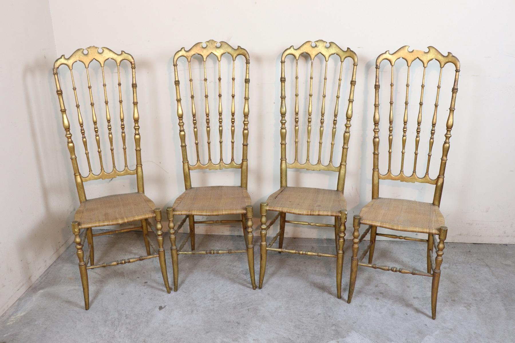 Very rare series of four chairs model Parigina production of Chiavari Italy cabinetmakers laboratories. All the golden chairs you see on sale are in brass but these chairs are antique 1890s made of turned wood and then gilded with gold leaf. The