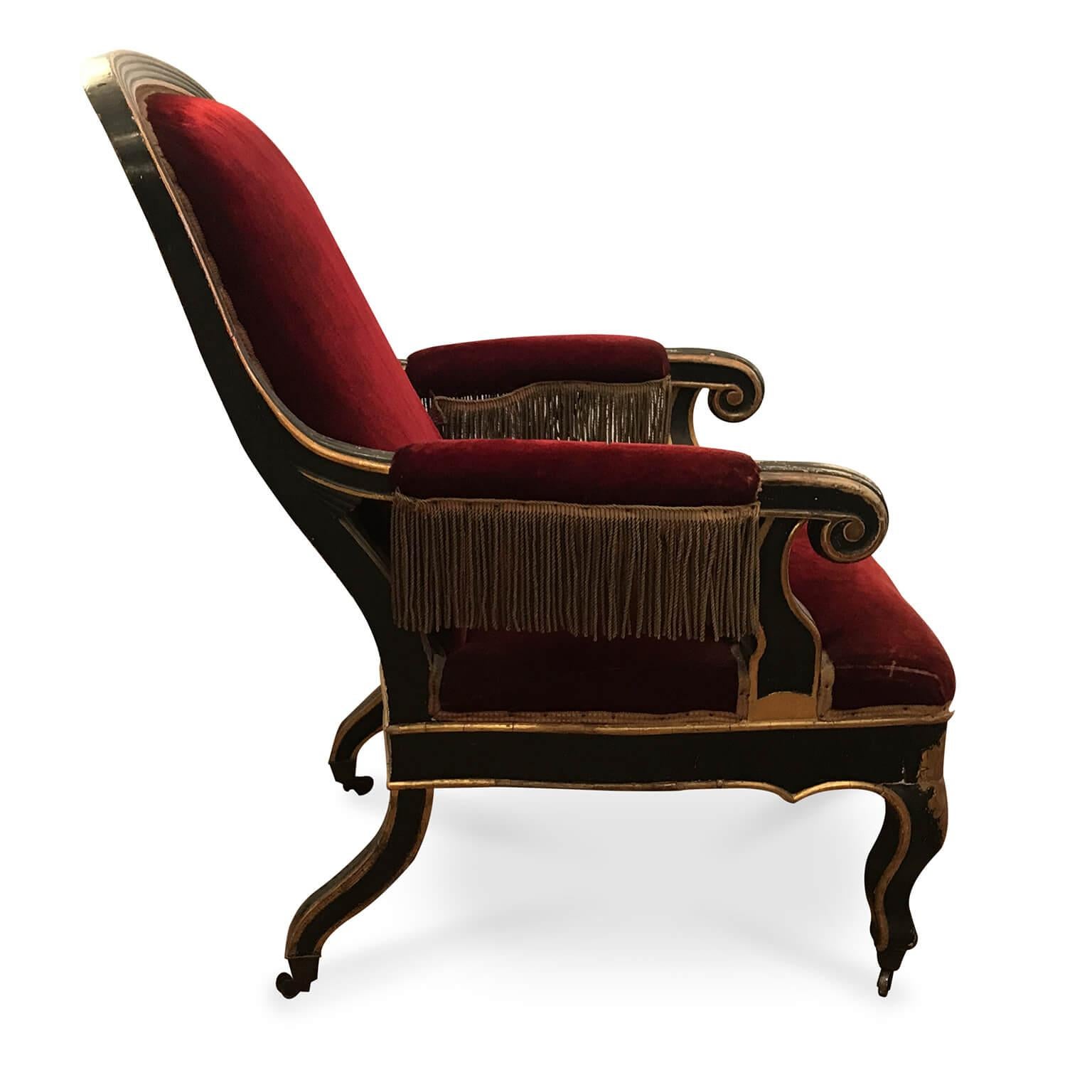 Antique Italian armchair from Sicily and matching footrest, an exclusive elegant Louis Philippe poplar armchair dating back to the last quarter of 19th century, with a dark lacquer wooden frame decorated with an elegant vegetal gilded motif and