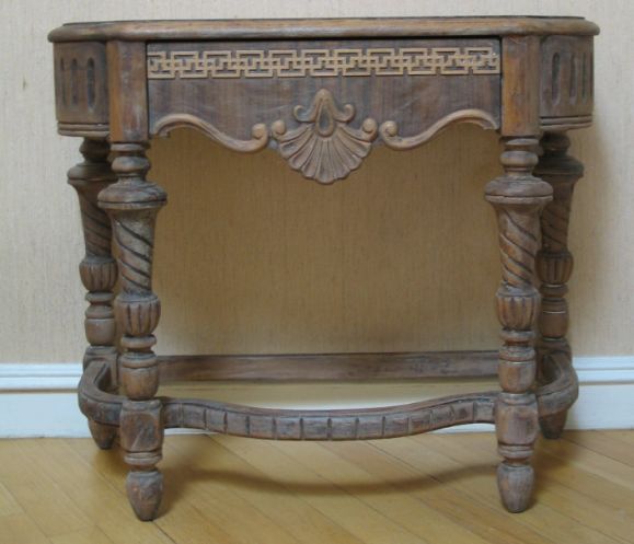Carved wood table with single drawer.