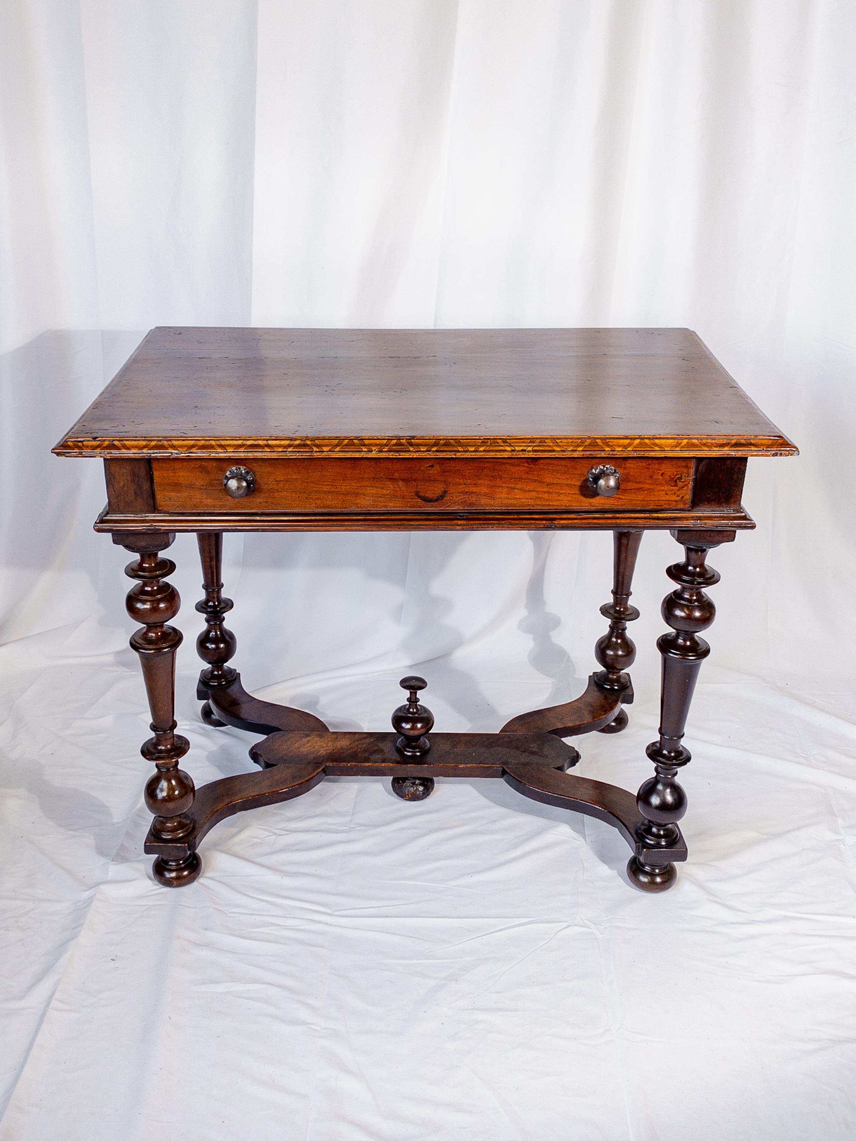 The 19th Century Italian Side Table with Walnut Marquetry Trim epitomizes the refined elegance of the era. Crafted with precision and artistry, this table boasts a rich walnut marquetry trim adorning its perimeter, showcasing intricate patterns and