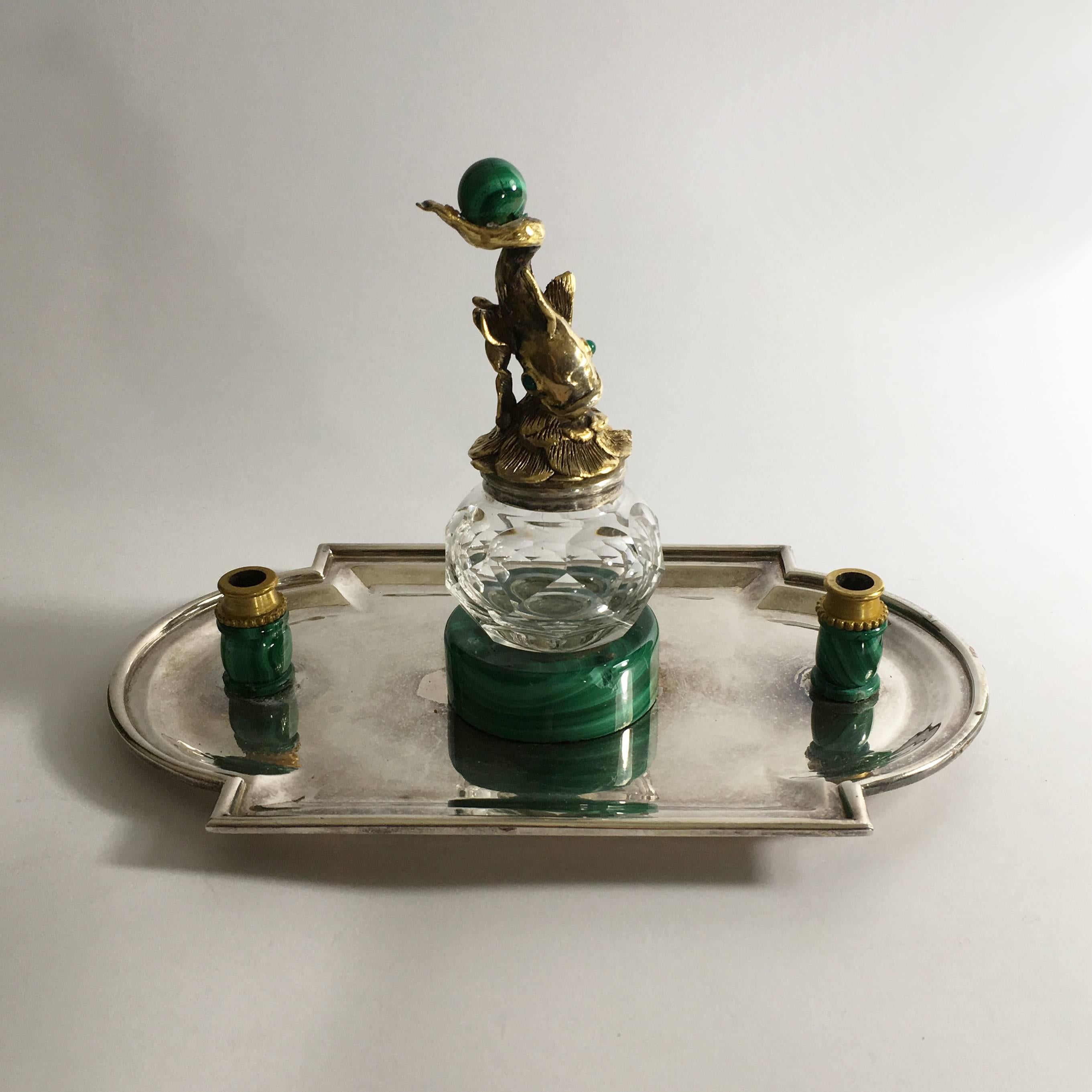 A very fine Italian 19th century silver, gilt bronze, malachite and crystal inkwell.
The silver base is surmounted by two pen holders in bronze mounted malachite and at the centre a crystal ink-reservoir raised on a malachite base.
The ink