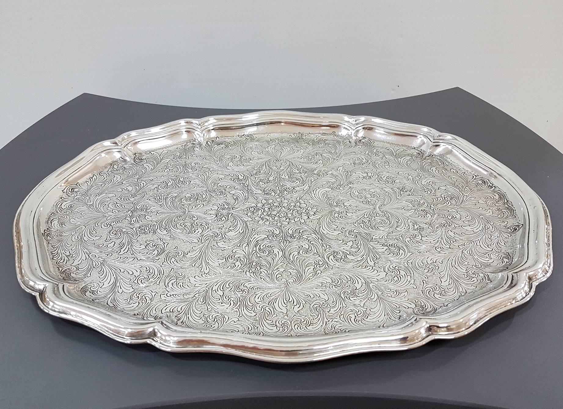 Baroque oval silver tray. Made in Milan, Italy in the mid-19th century.

Completely hand engraved with scrolls and central flowers. The swirls and flowers are highlighted by a very thick knurl too made by hand.



        