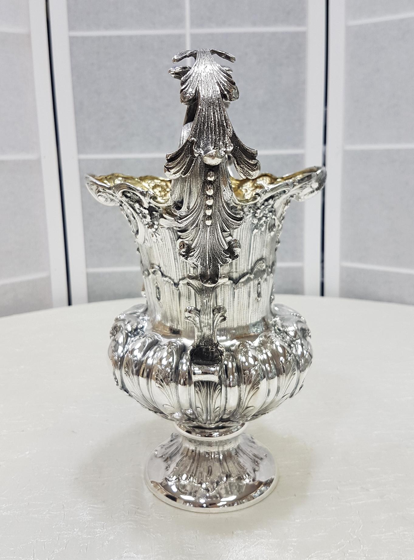 Gorgeous Italian solid silver vase. Body made in one piece without welding. Embossed and chiseled, of rare beauty and precision. Two important handles made of fusion and finely chiseled were welded onto the vase. The inside of the vase has been