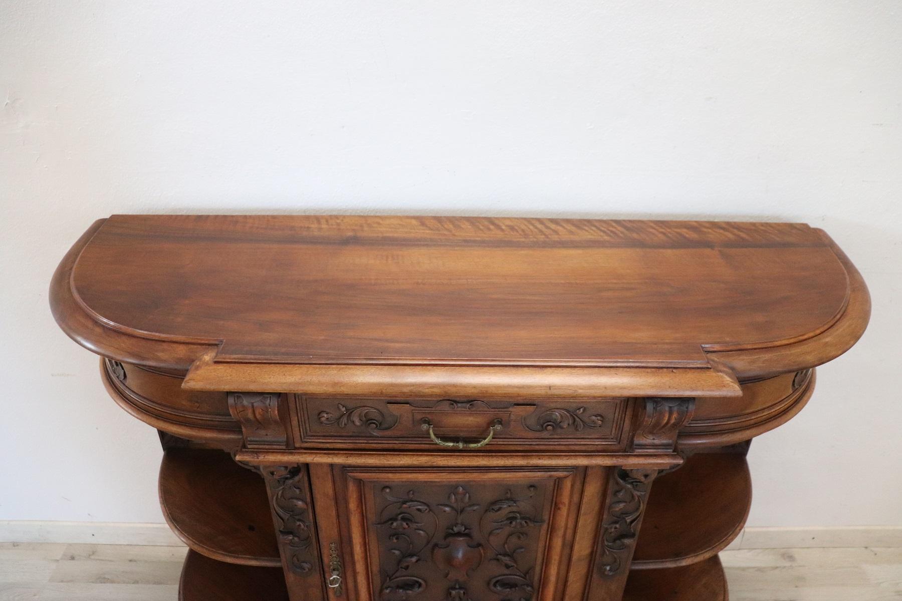 Antique Italian sideboard 1880s in solid walnut wood of a beautiful antique patina! It is characterized by a refined decoration carved in walnut wood of Renaissance taste. Particular round shape on the sides. Due to its refinement it can also be