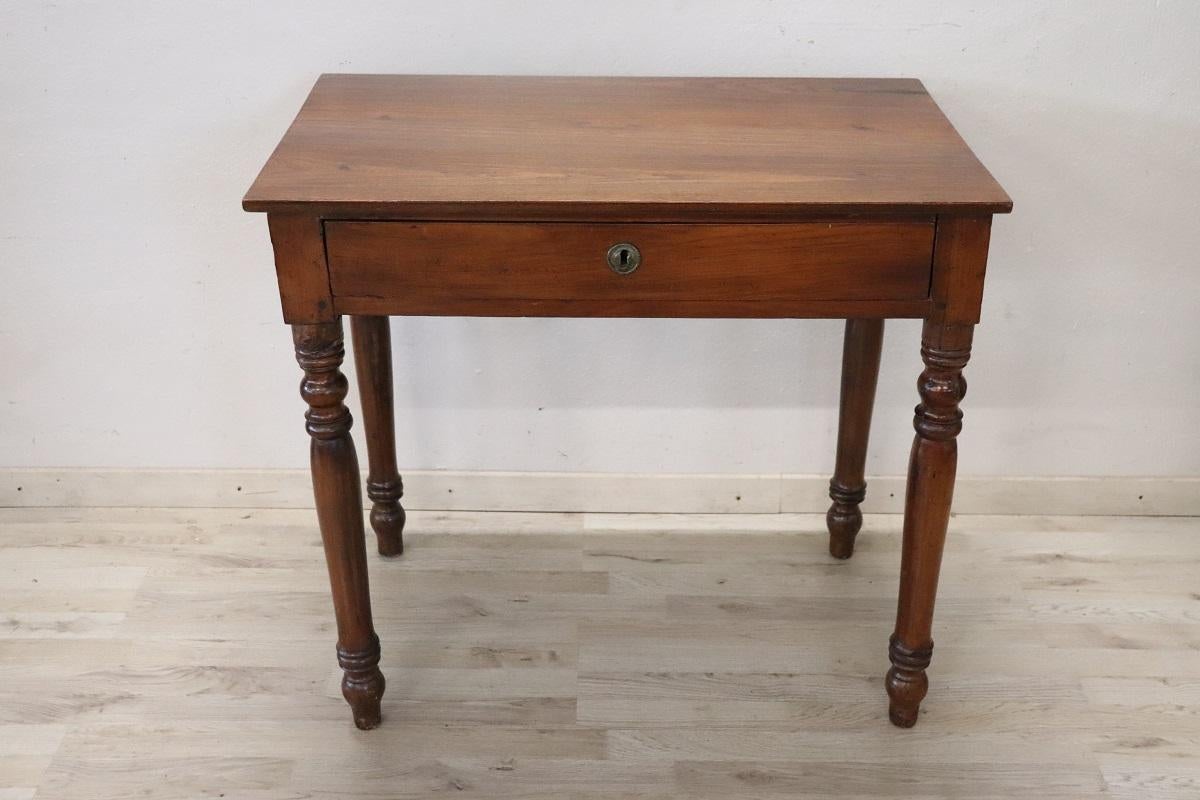 essential antique Italian small writing desk. The desk is made of solid walnut wood. Important turned legs. Equipped with one comfortable large drawer on the front. Due to its small size, this table is perfect for any room in the house, you can use