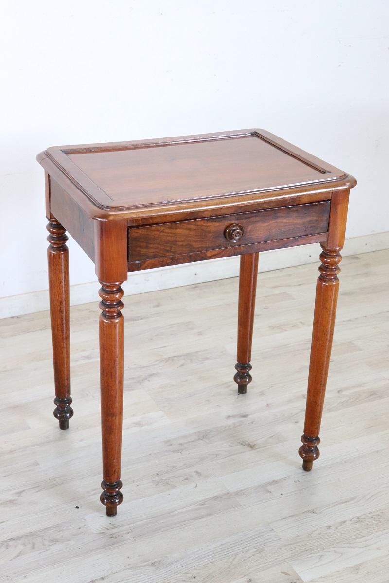essential antique Italian small writing desk or side table. The table is made of solid walnut wood. Important turned legs. Equipped with one comfortable large drawer on the front. Due to its small size, this table is perfect for any room in the