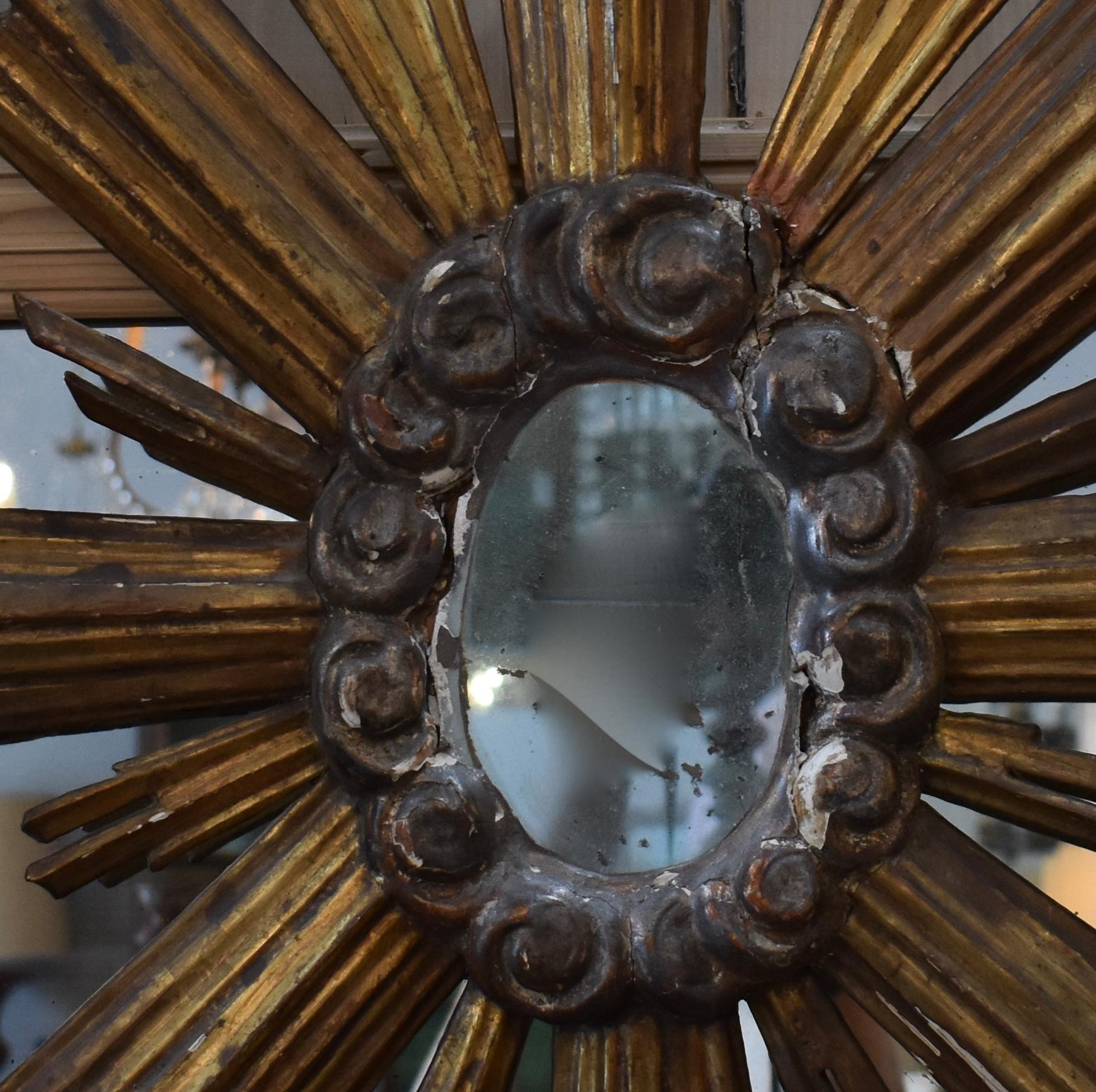 19th century Italian gilded church sunburst mirror. Great hints of gold, silver and red. All original.