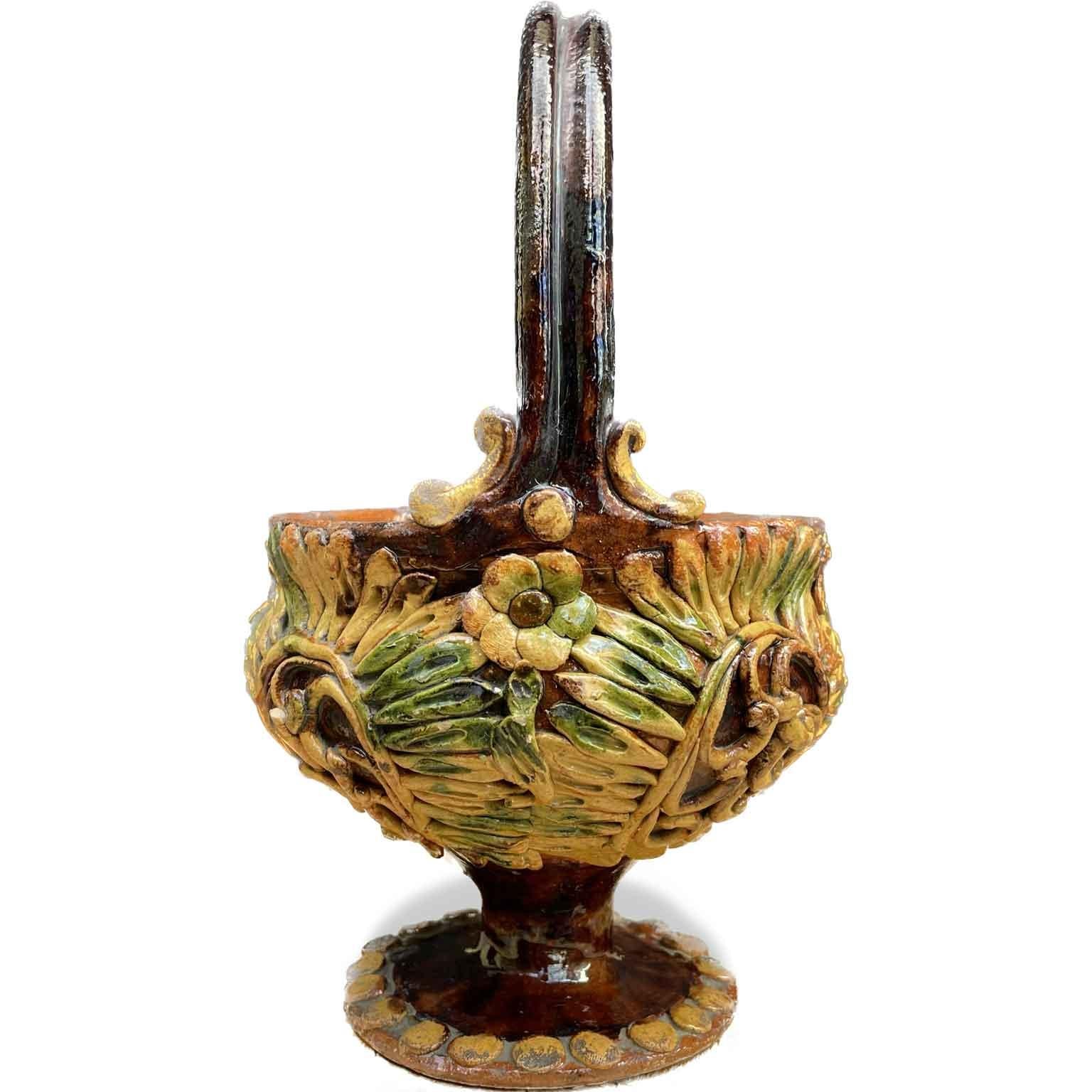 From Tuscany a ceramic basket realized with a circular vase with polychrome geometric decorations on the body and a relief decoration handmade by applied flowers and scrolls as well as on the handle.
A Mid-19th Century Italian ceramic warmer, a