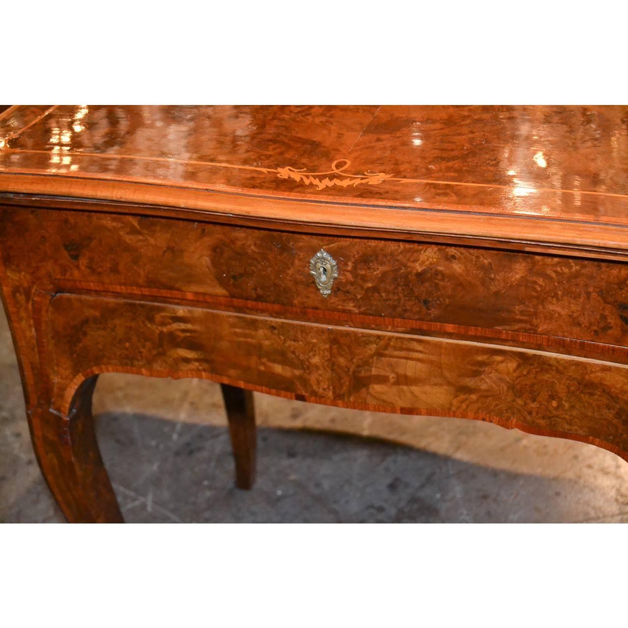 Creatively designed 19th century Italian burl walnut and satinwood inlaid tray top writing table/book stand on cabriole legs ending in cast bronze sabots.

The top removes and slides out to form a tray top with fitted interior and lift up book