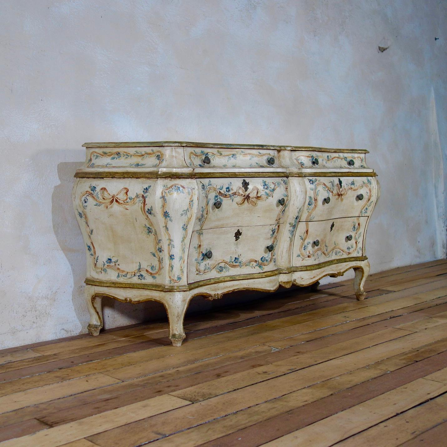 An exceptional 19th century Italian - venetian original painted bombe sideboard - Commode. Displaying a simulated marble top above six floral decorated serpentine drawers, raised on squat cabriole legs. 

Height - 69 cm
Width - 146 cm
Depth - 49 cm