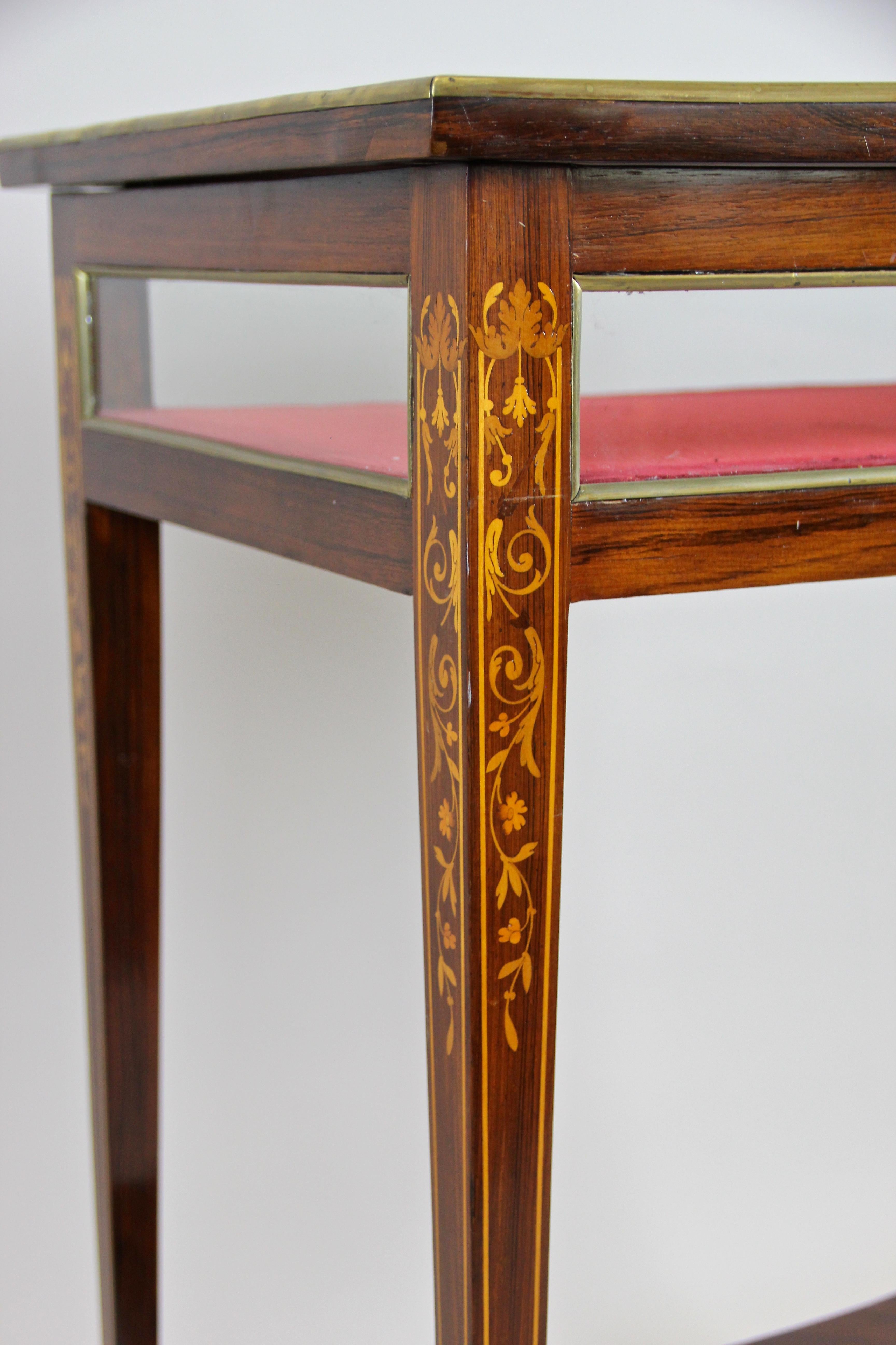 Outstanding late 19th century vitrine table with inlay works out of Italy, circa 1890. The elaborately processed display table impresses with a beautiful veneered palisander surface, adorned by fantastic inlay works around the frame of the glassed