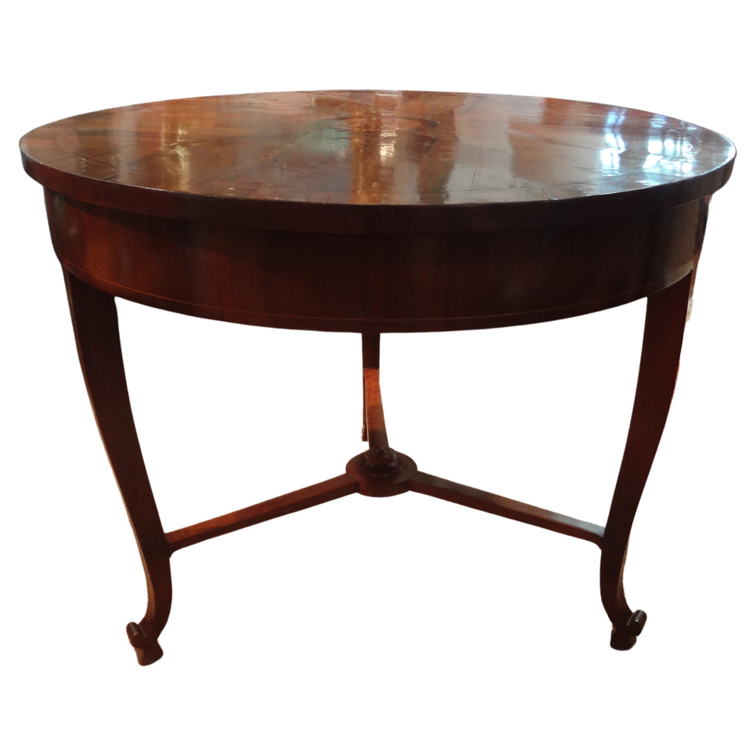 19th Century Italian Walnut Center Table Or Game Table.
This unusual antique Italian Neoclassical style walnut center table or game table has a beautiful marquetry central inlaid  design, a drawer and three legs.
A versatile table that can be used