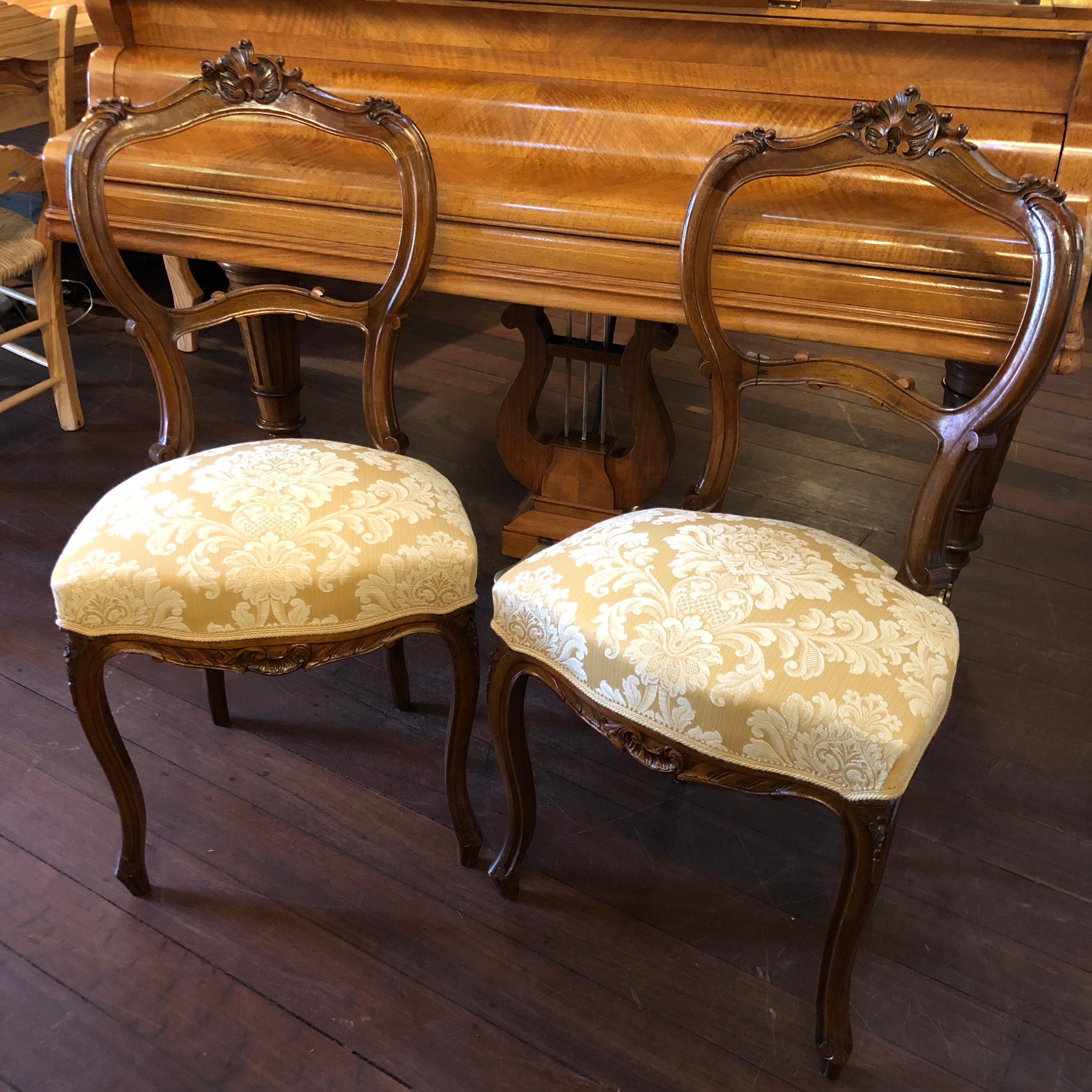 This beautiful pair of 19th century. Italian Walnut chairs feature crème yellow patterned upholstery and walnut frames. They were originally found by us in the Veneto region of Italy and would perfectly compliment a ladies office desk or could be
