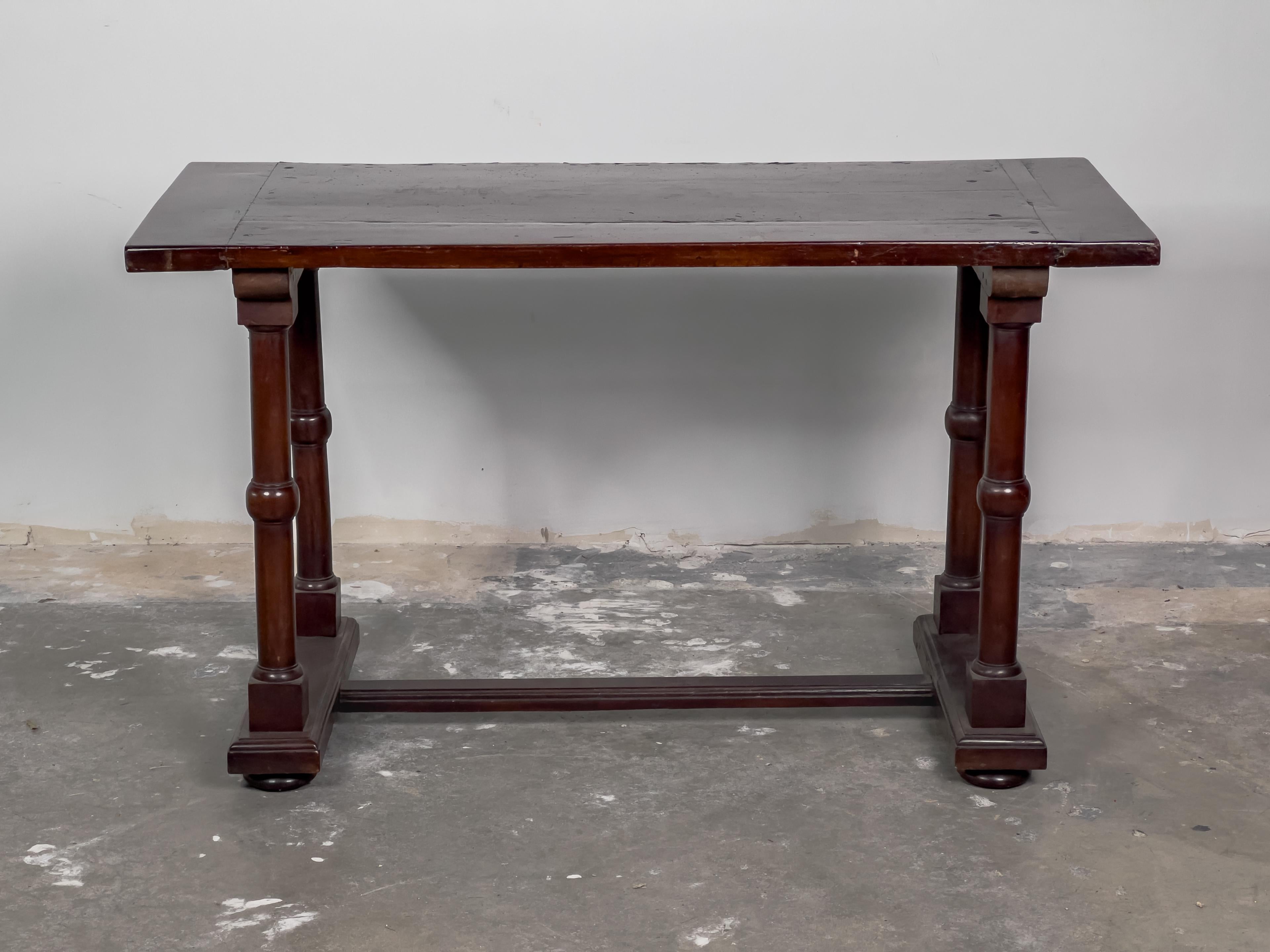 This 19th Century Italian Walnut Console Table exudes timeless elegance and exquisite craftsmanship. Crafted from rich walnut wood, it boasts a luxurious depth of color and a lustrous sheen that highlights the natural beauty of the wood grain. The