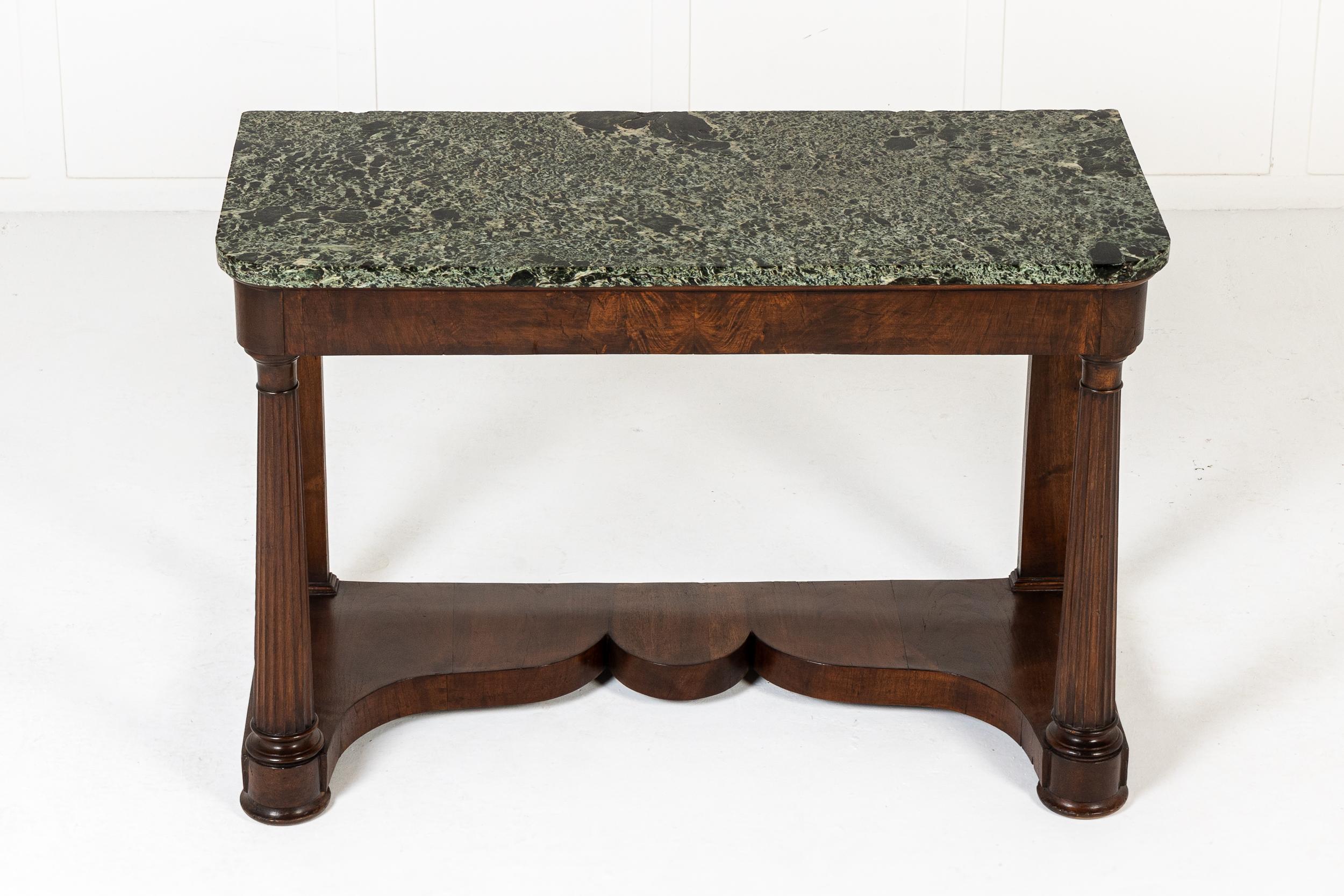 A 19th Century Italian Walnut Console Side Table with Marble top.

This interesting table has an exceptional, beautifully figured green and black marble top above a plain frieze. Supported by four turned and tapering columns with fluted detail, and