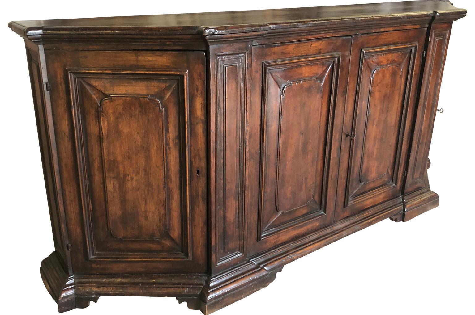 A very handsome mid-19th century credenza from the Veneto region of Italy. Soundly constructed from rich walnut with canted sides and four molded door panels. A wonderful storage piece. Excellent patina.