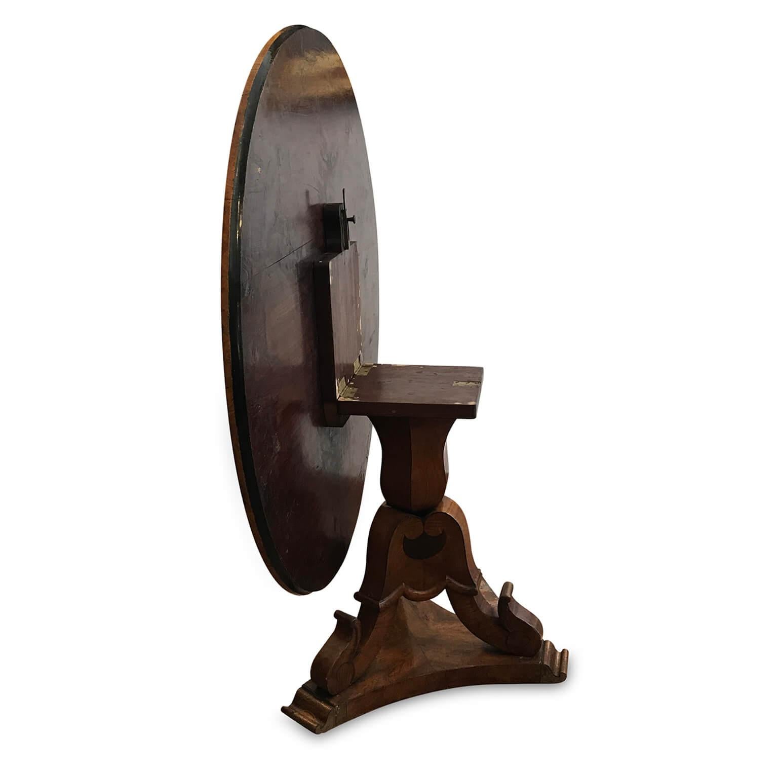 Antique Italian walnut table, a circular tilt-top table dating back to the late 19th century, standing on squared section scrolling tripod legs resting on a shaped basement. May be perfect for your living and dining room as well. The table is in