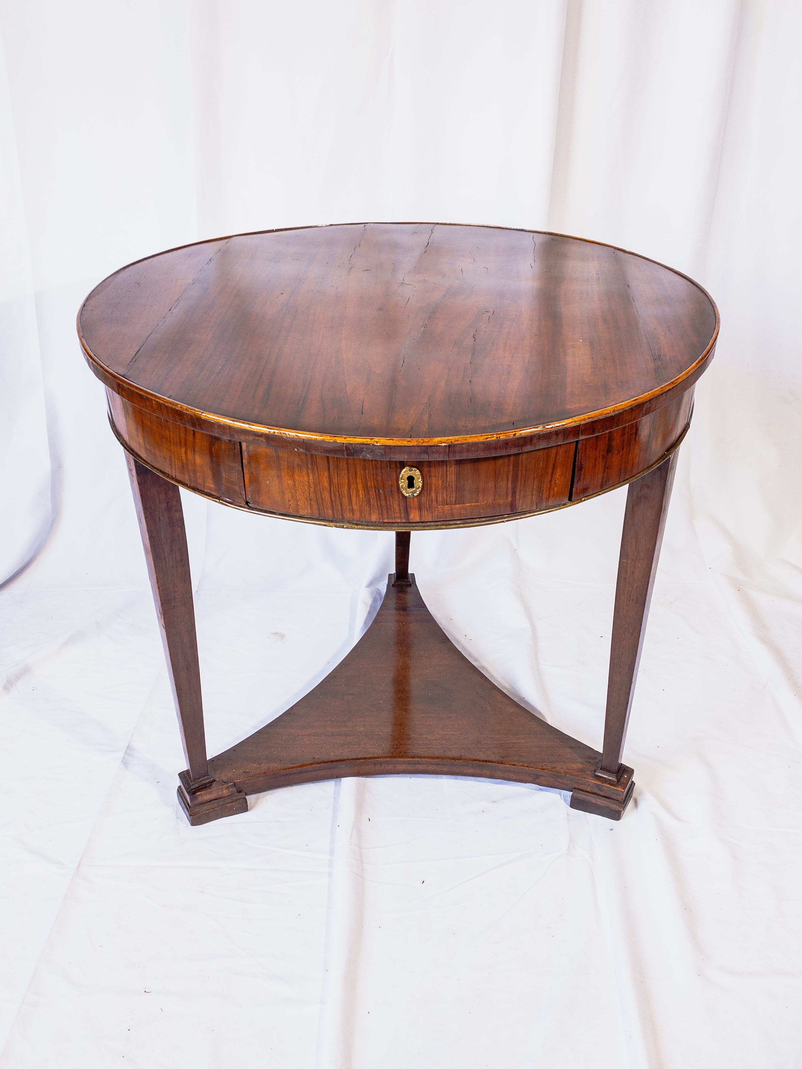A remarkable piece of 19th-century craftsmanship, this Italian Walnut Round Wooden Table boasts both functionality and beauty. Its round top, crafted from rich walnut wood, showcases the warmth and depth of the material, inviting tactile