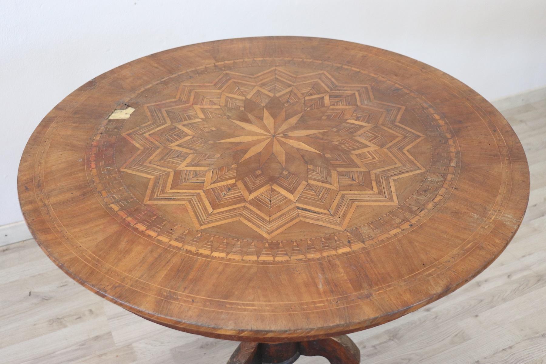 Beautiful important antique round table, 1850s in walnut. The plan presents precious work of inlay. The inlaid decoration is of geometric and floral taste made with small pieces of different and precious woods. Please look at all the images to