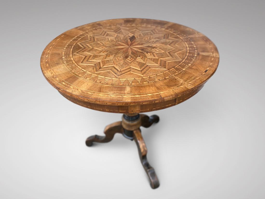 A very fine antique 19th century Italian walnut marquetry pedestal tripod occasional table, from the Sorrento region in fine walnut marquetry and other warm coloured woods. The edge of the table with inlay standing on a pedestal base, divided into