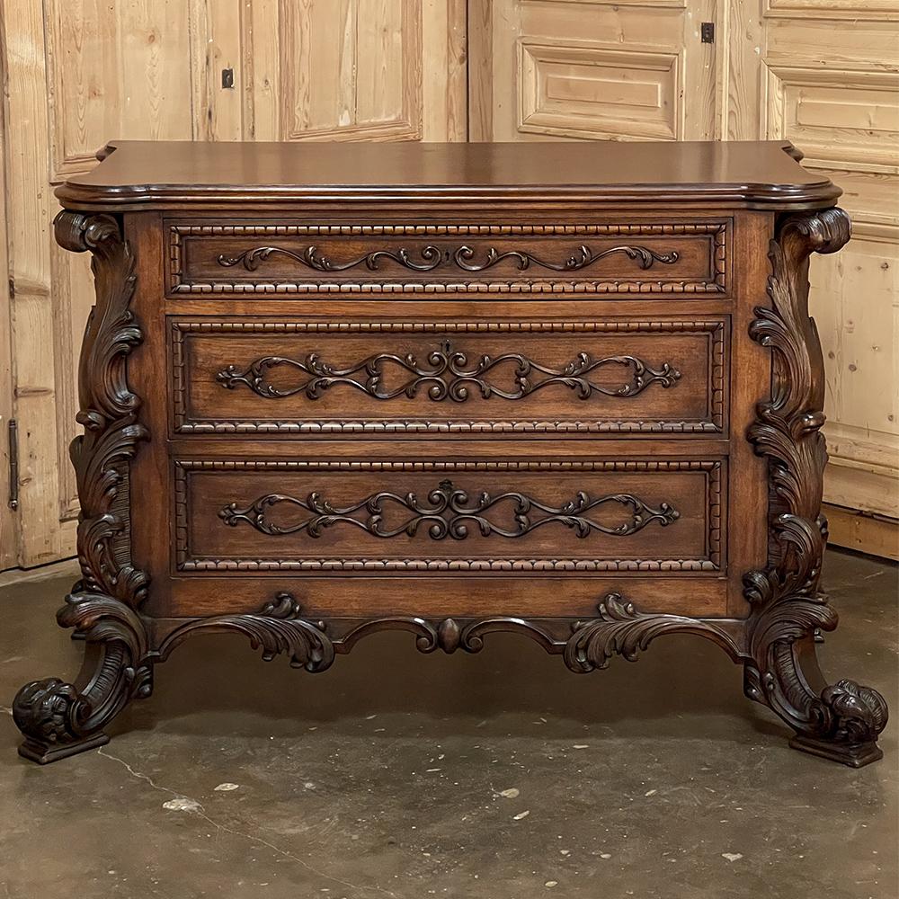19th Century Italian walnut rococo commode is a celebration of the Baroque style blended with the French influence of the shell motif hence the colloquialism ~ rococo. The exuberant acanthus plumes and shell design that adorn each of the four