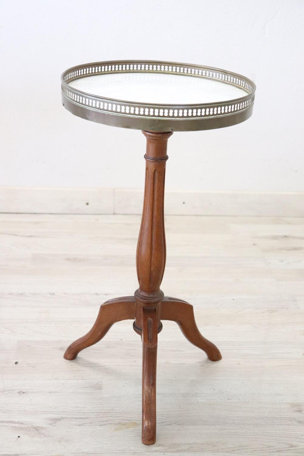 Rare and fine quality Italian round side table or pedestal table. The table presents a refined turned work in walnut wood. Precious white marble top with decorative brass border. Perfect to be used in your living room.
Used, perfect conditions.
 