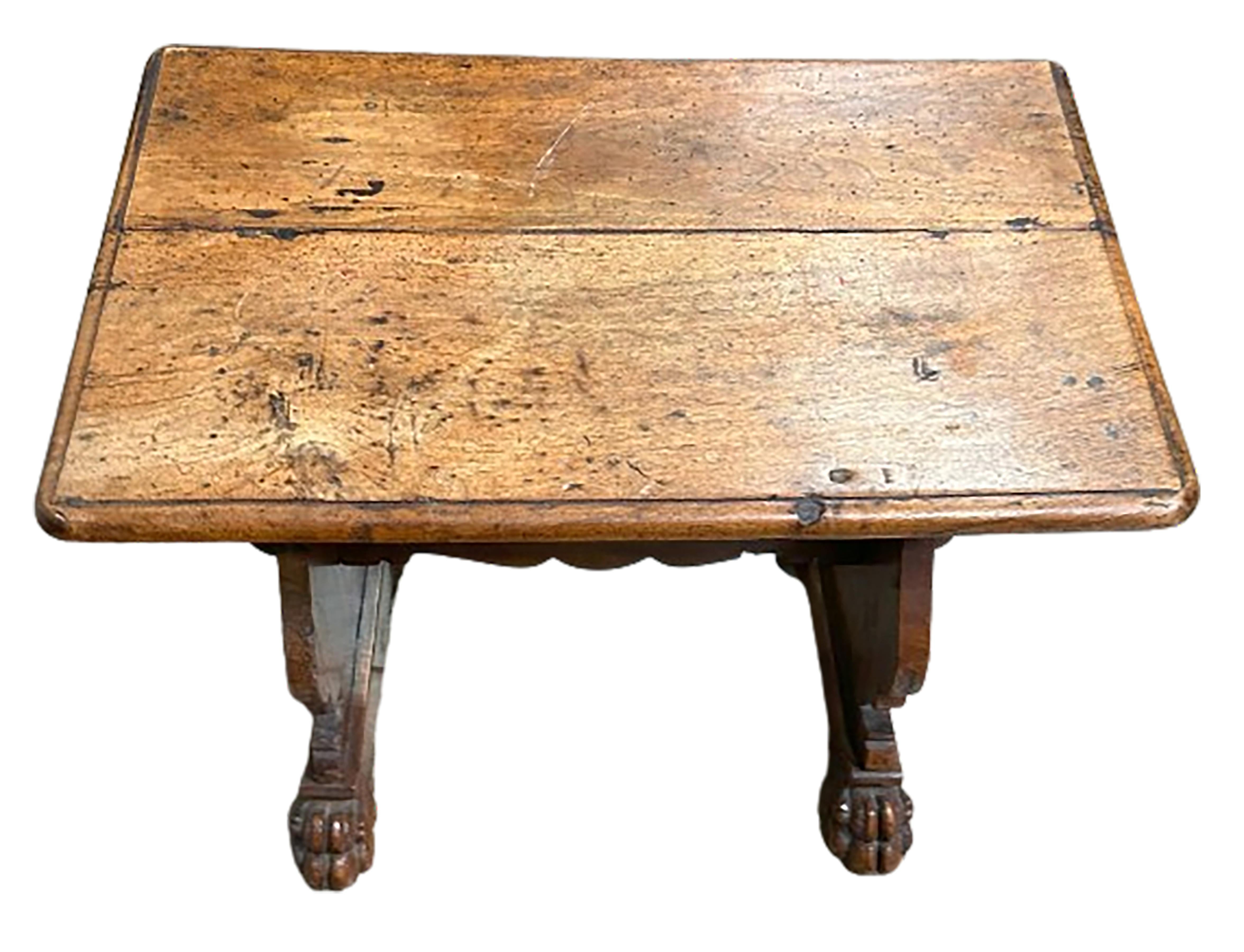 A handsome 19th century Italian walnut side table. Top is made up of two boards. Sides are joined with two lions paw feet at either side of the bottom. Deep patinated finish. 

In good condition. Some gentle wear consistent with age and use.

No