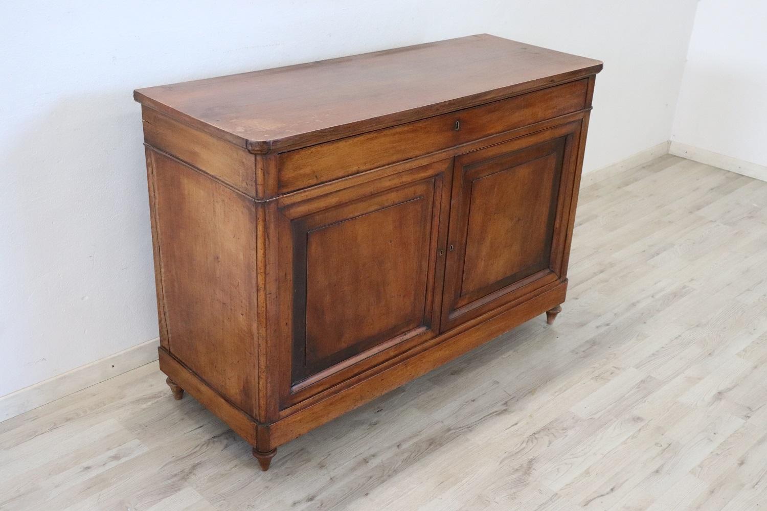 Beautiful sideboard in solid walnut wood made in 1850s. The line is simple and essential, perfect to be placed also in a modern environment. Beautiful patina of walnut wood. Ample useful internal space equipped with one comfortable long drawer. The