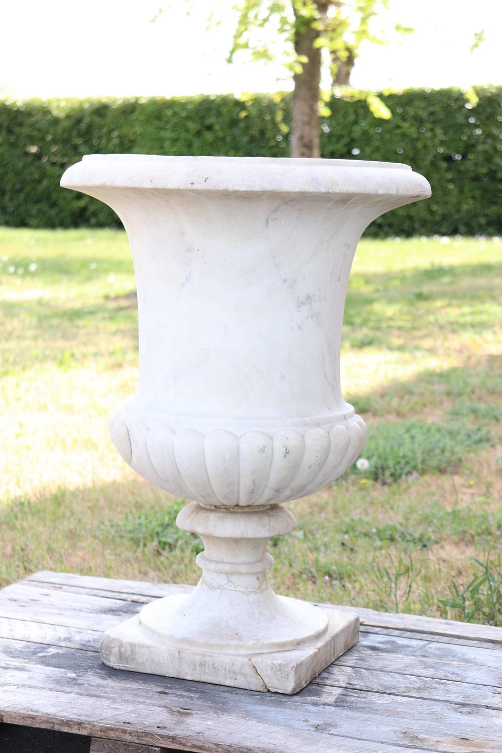Beautiful refined garden ad outdoor vase. Beautiful and majestic in italian white Carrara marble. The vase has a refined Classic decoration in sinuous Medici shape. The marble shows signs of the passage of time and some repairs. This vase is perfect
