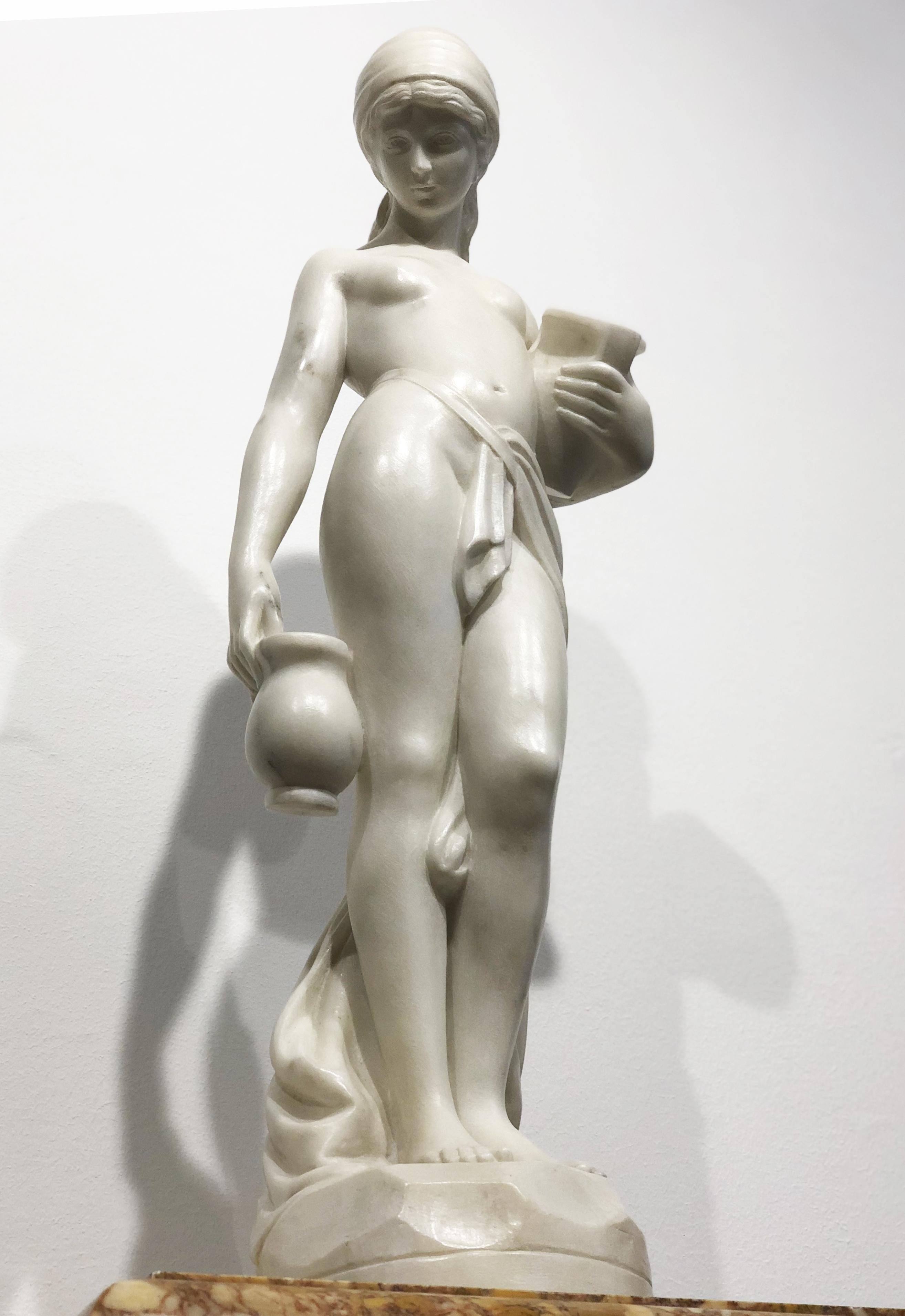 A very elegant sculpture of a young woman that is carrying to jugs, probably she is bringing the water. It was very common in art tie together woman and water , and the woman is likely representing the earth element and the life.
Example are found