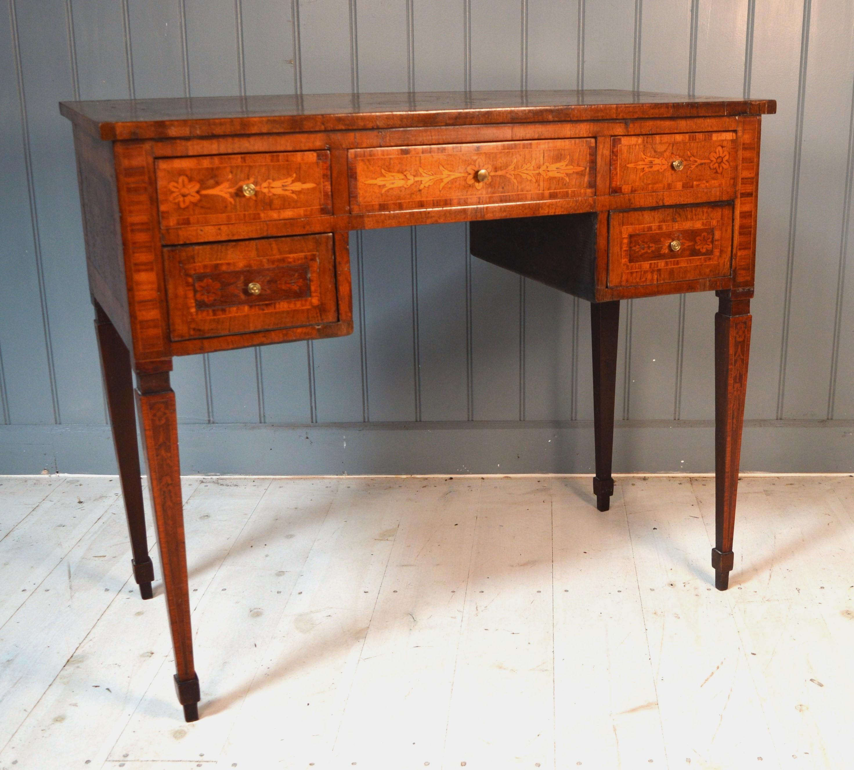 Early 19th century Italian marquetry writing table with five drawers. Various timbers in the marquetry including kingwood, walnut, box and tulip. This piece has a fairly untouched country house finish and is not repolished. It was bought from a