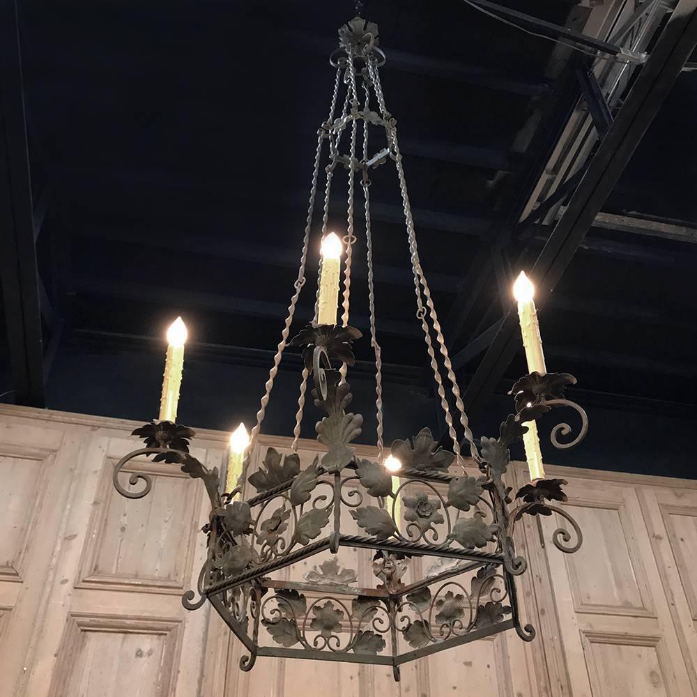 19th century Italian Country wrought iron chandelier was designed to enrapture all who enter the room, as only antique lighting can! From the lavish foliates and rosetes to the extended, scrolled arms adorned with oak leaves and florets for