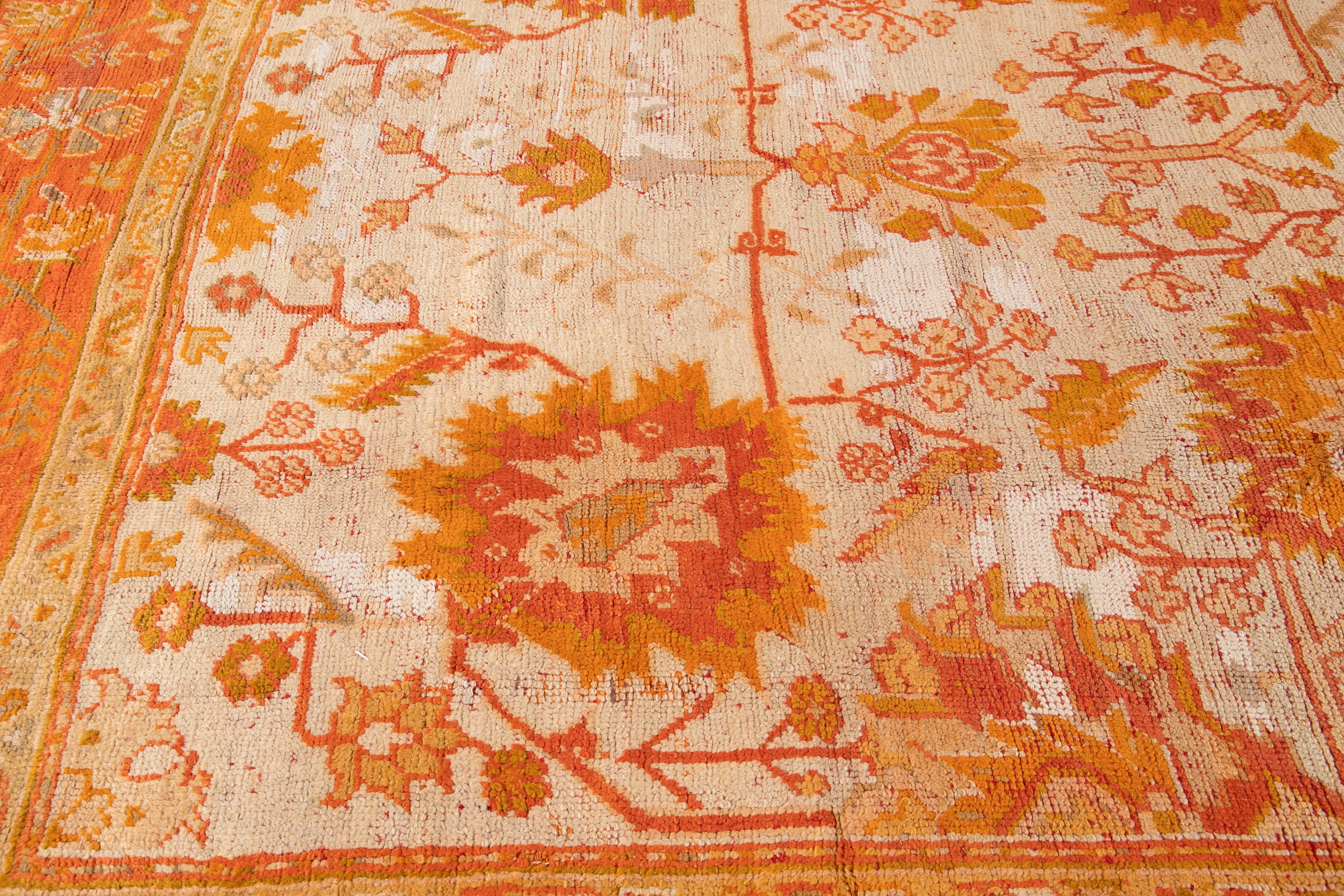 Wool 19th Century Ivory and Orange Turkish Oushak Rug For Sale