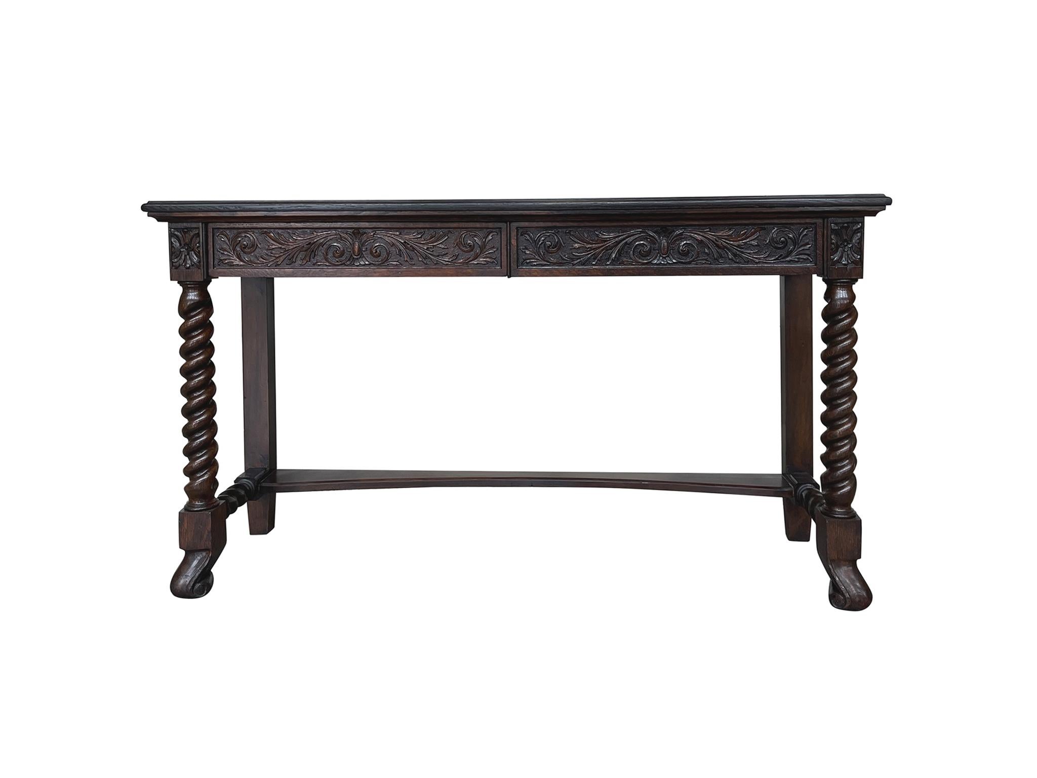 Handcrafted in the 19th Century, this console table consists of warm, red-brown oak wood constructed with a single left drawer. The wood has been beautifully refinished. Hand-carved floral motifs adorn the front and side panels. The front legs are
