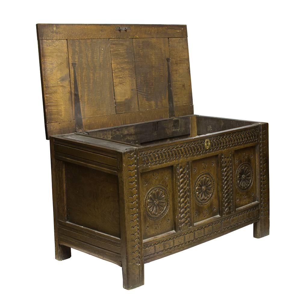 This gorgeously carved continental trunk is a later 19th century nod to England’s Jacobean decorative heritage. Skillfully crafted, the solid oak is sturdy with a rich dark stain that offsets the bright brass escutcheon and depth of the carved