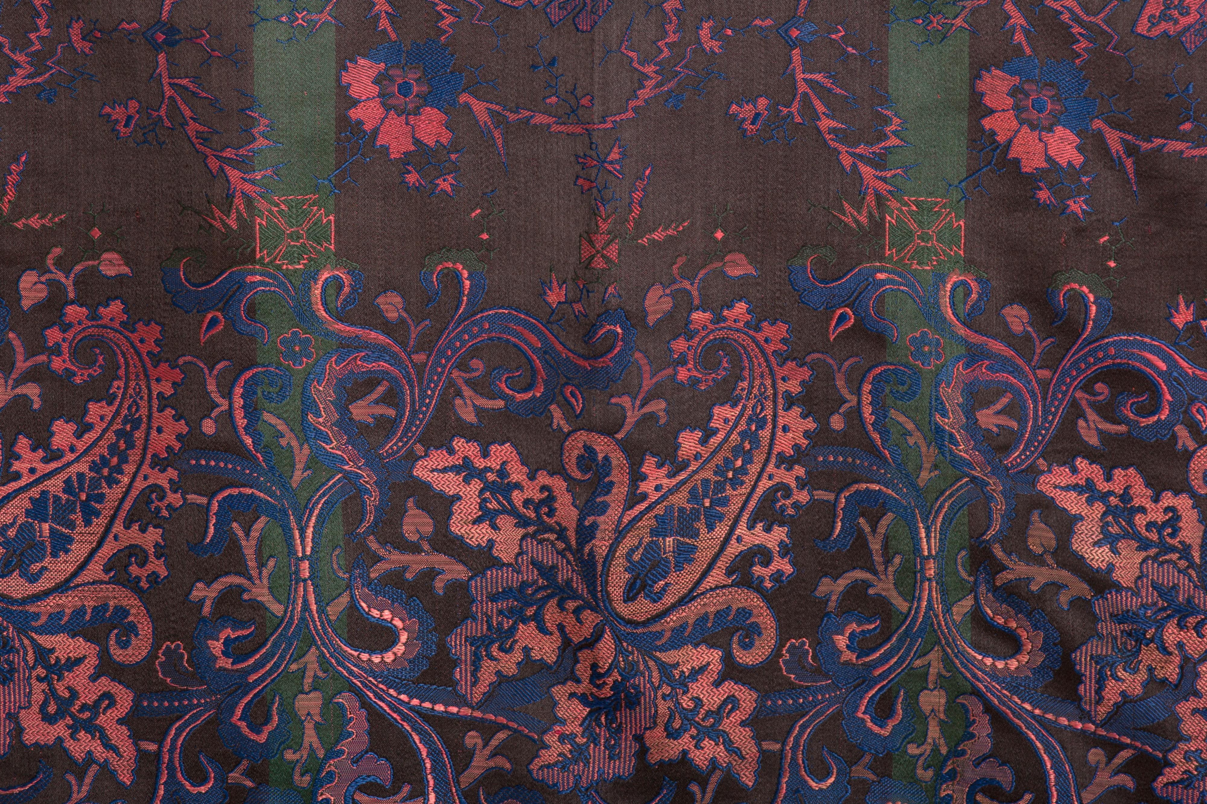 Stylized floral and boteh motifs. This jacquard woven silk shawl is a prime example of expert silk textile manufacturing in Lyon during the 19th century. Bright pink, green, blue wefts create complex weave structures across a black warp. Applied