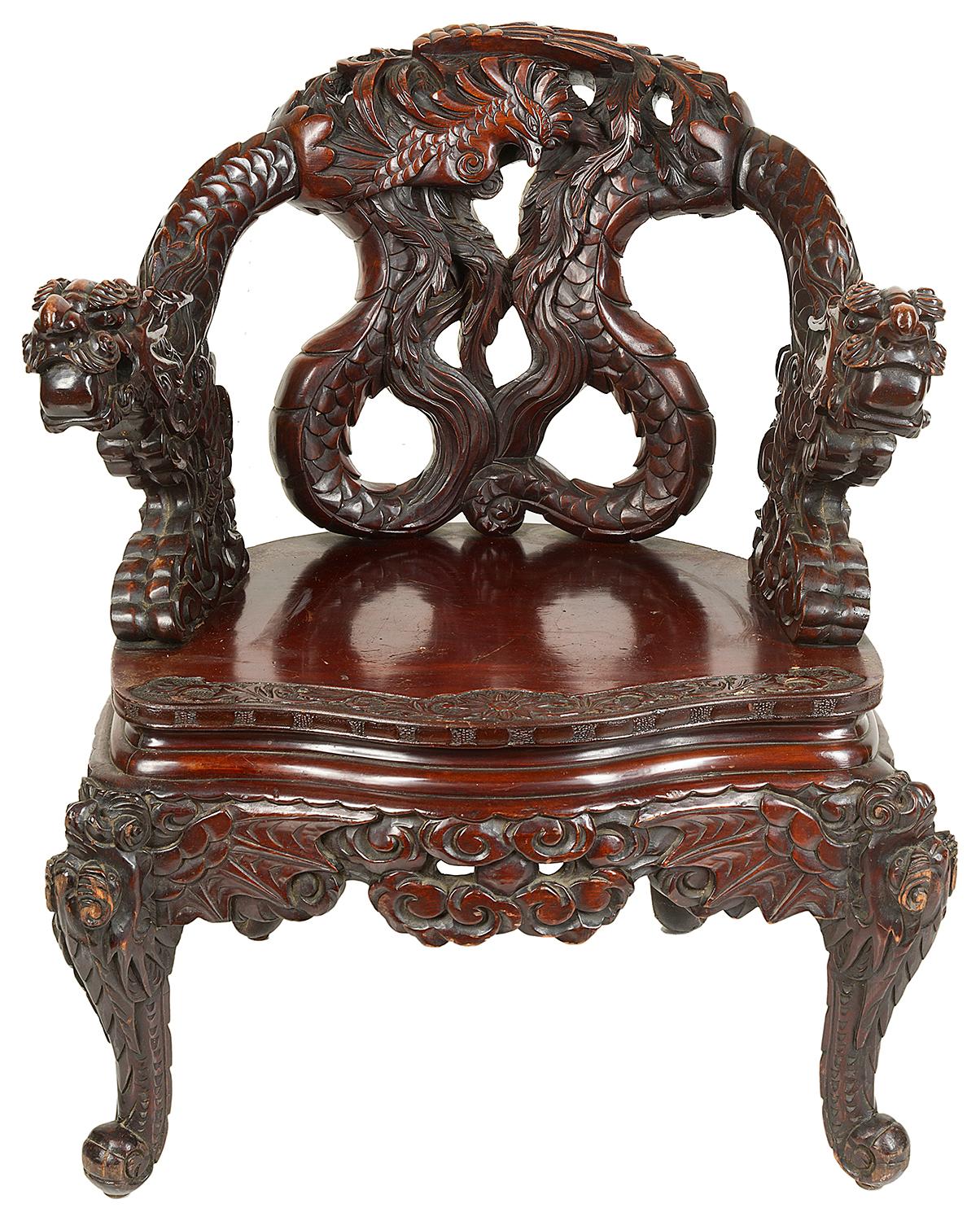 A very dramatic late 19th century Japanese carved softwood armchair. Having mythical dragons entwined to the backrest and arms, raised on carved cabriole legs.