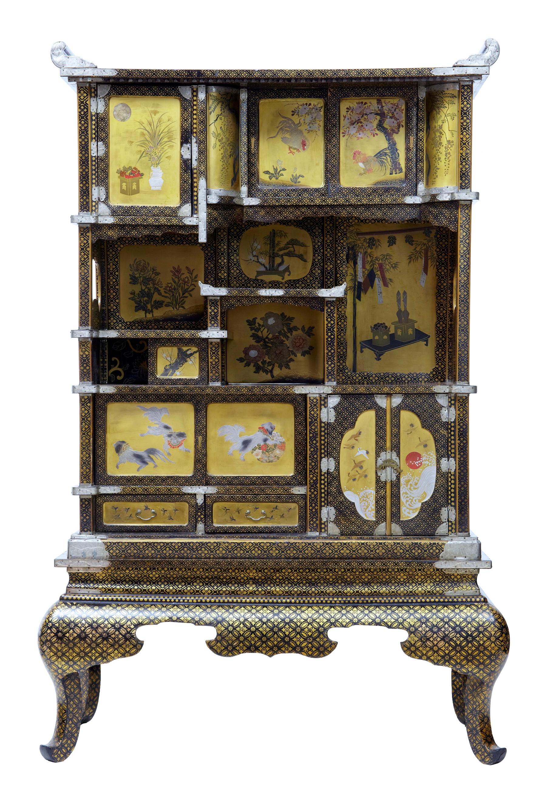 Superb quality Japanese display cabinet, circa 1890. Contains various scenes from Japanese life on the gold panels, showing birds, dogs, flowers and foliage. Decorated front and back and on the inside as well. Splits at the base. Compartments