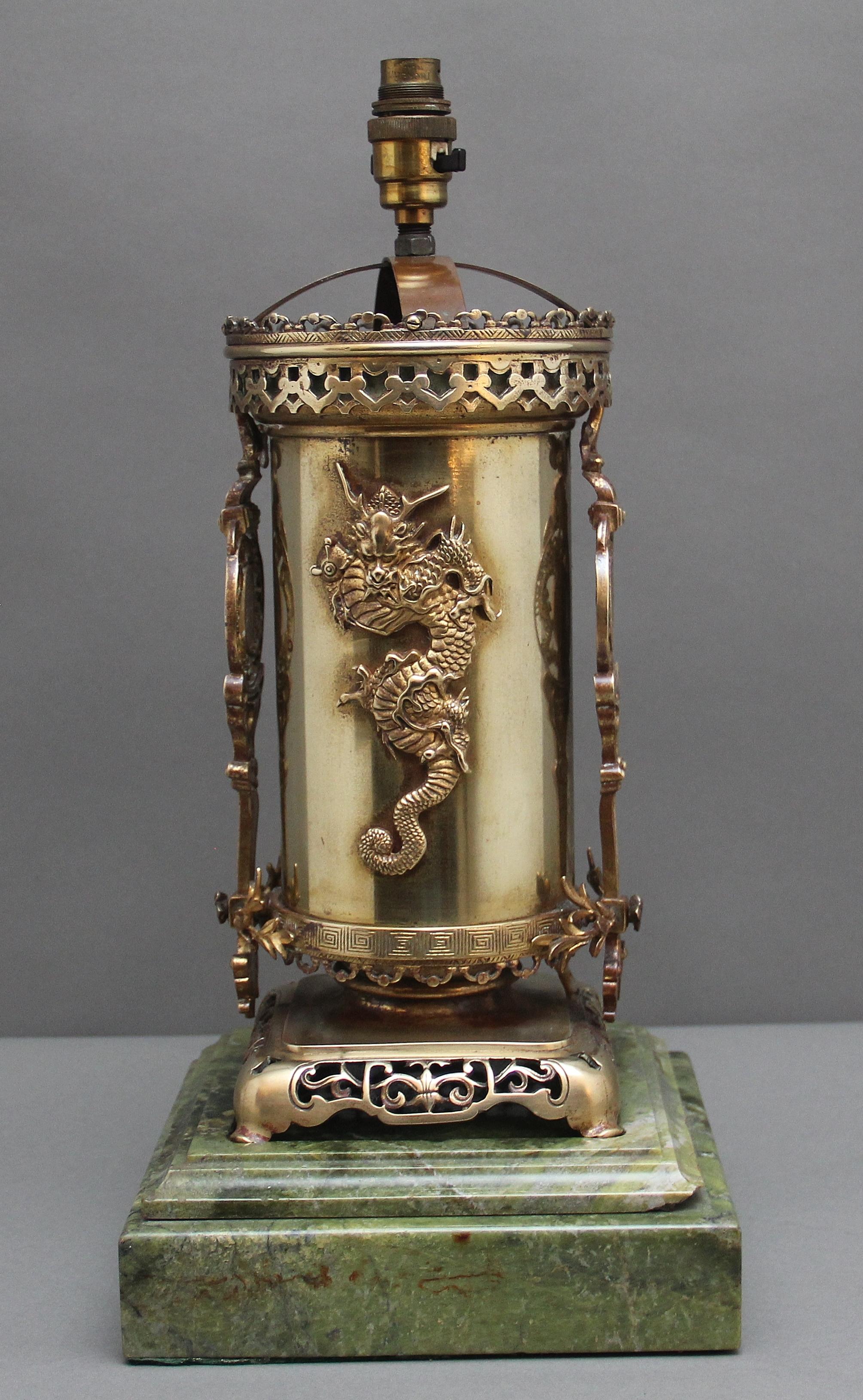 A lovely quality 19th Century Japanese  lamp in the oriental manner, with ferocious dragons and intricate pierced decorations, sitting on a green platform marble base.  Fitted for electricity.   Circa 1880.  Please note there are some chips to the