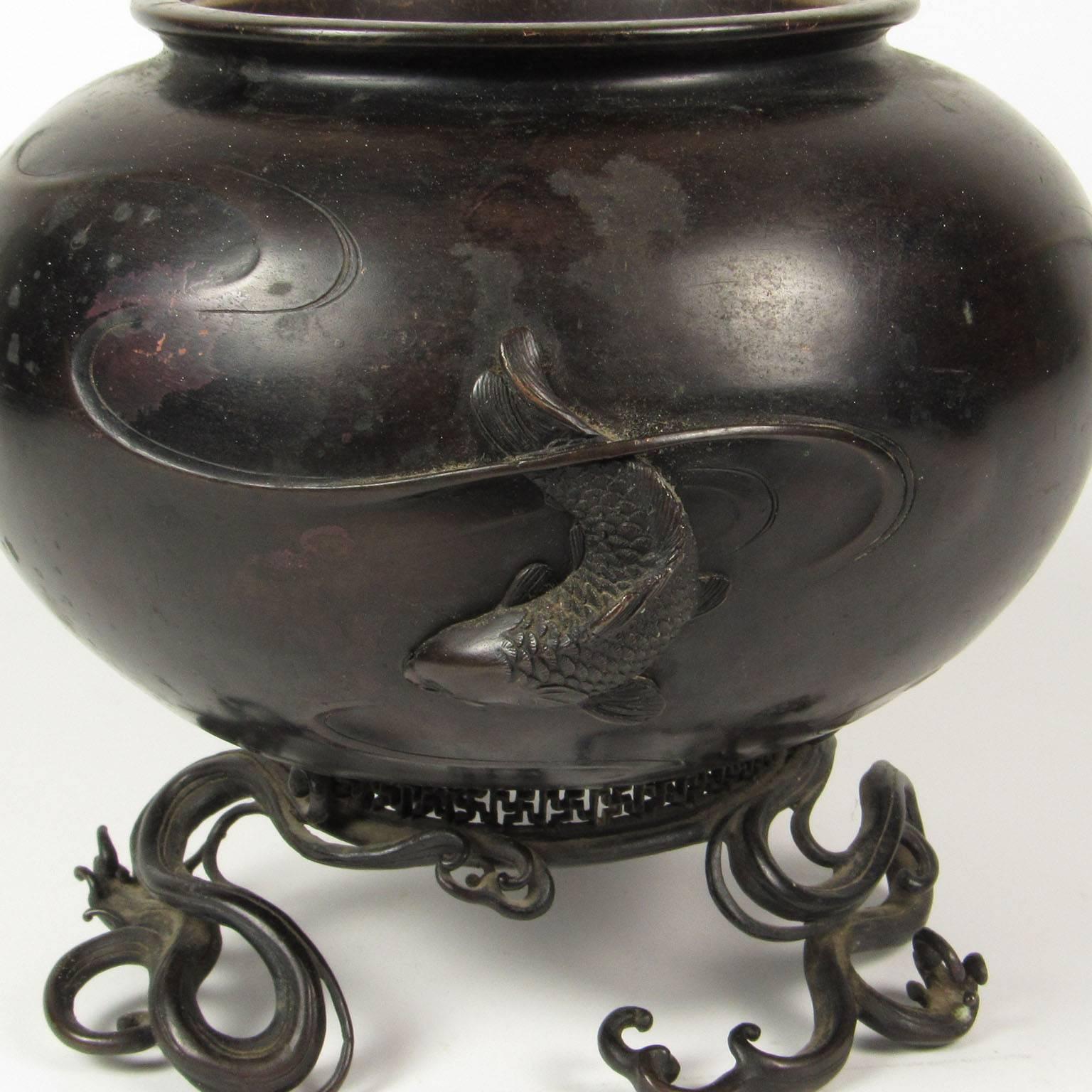 Meiji or Edo period Japanese bronze footed censor with Koi decoration and cloud band feet. Exceptional quality. Maker’s mark on bottom. Measures: Height: 6 1/2 inches, diameter: 8 inches. Provenance available to buyer.