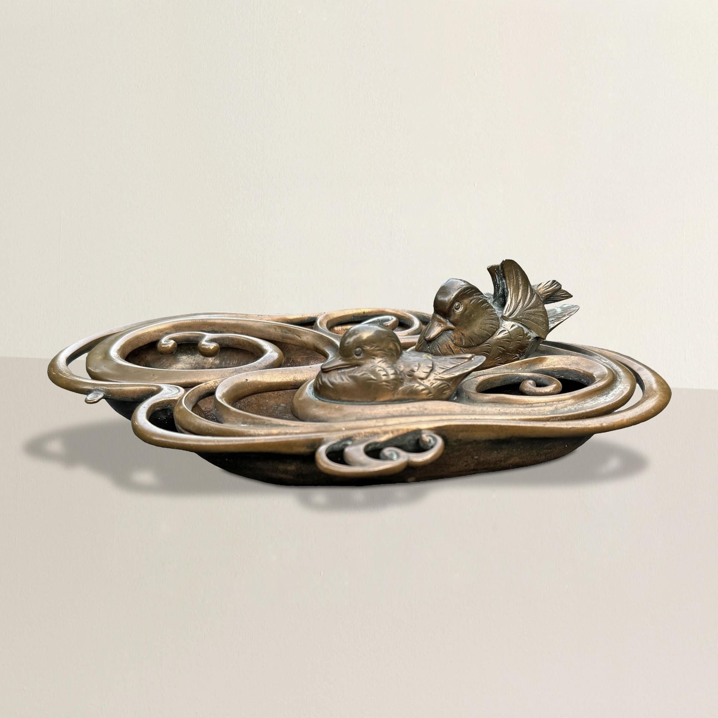 This exquisite 19th-century Japanese Meiji bronze incense burner, artfully crafted in the form of a pair of ducks gliding gracefully on a serene pond, is a testament to the skilled artisanship of the Meiji period. The intricate pierced bronze top,