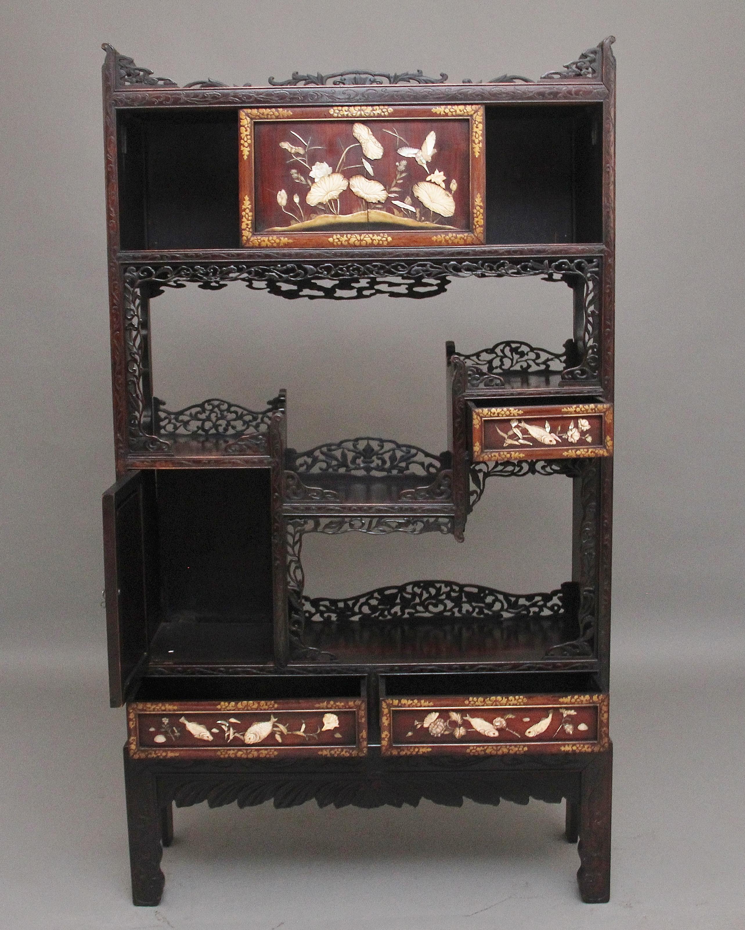 A superb quality 19th Century Japanese Meiji period shibayama shodhana, the rectangular top with a decorative pierced and carved shaped gallery above a pair of sliding doors,  a stepped niche and an arrangement of drawers and cupboard with further