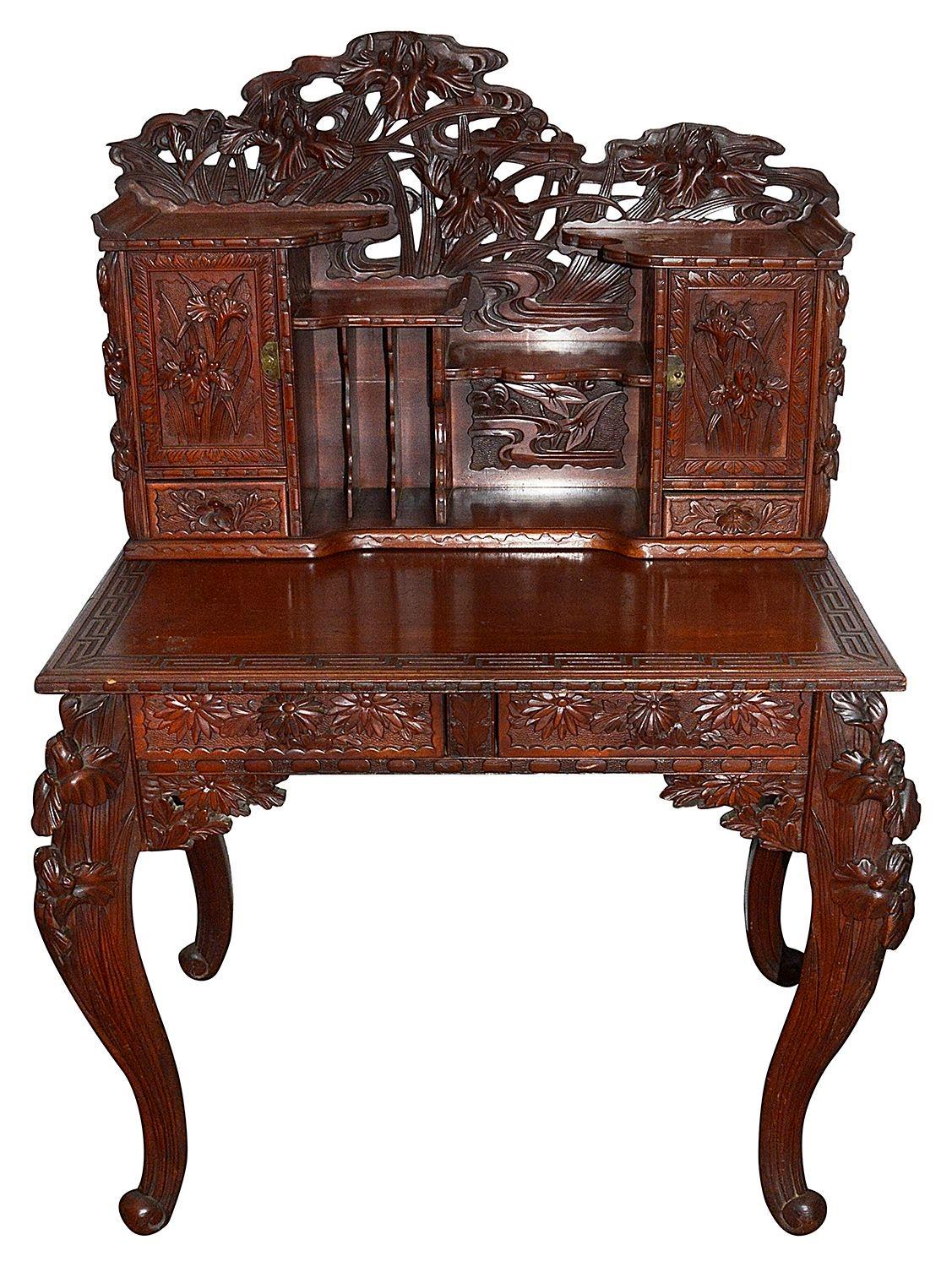 A good quality Japanese carved wood desk, having wonderful carved exotic flowers and foliage to the cupboards, drawers and elegant cabriole legs.
Batch 75

Batch 75