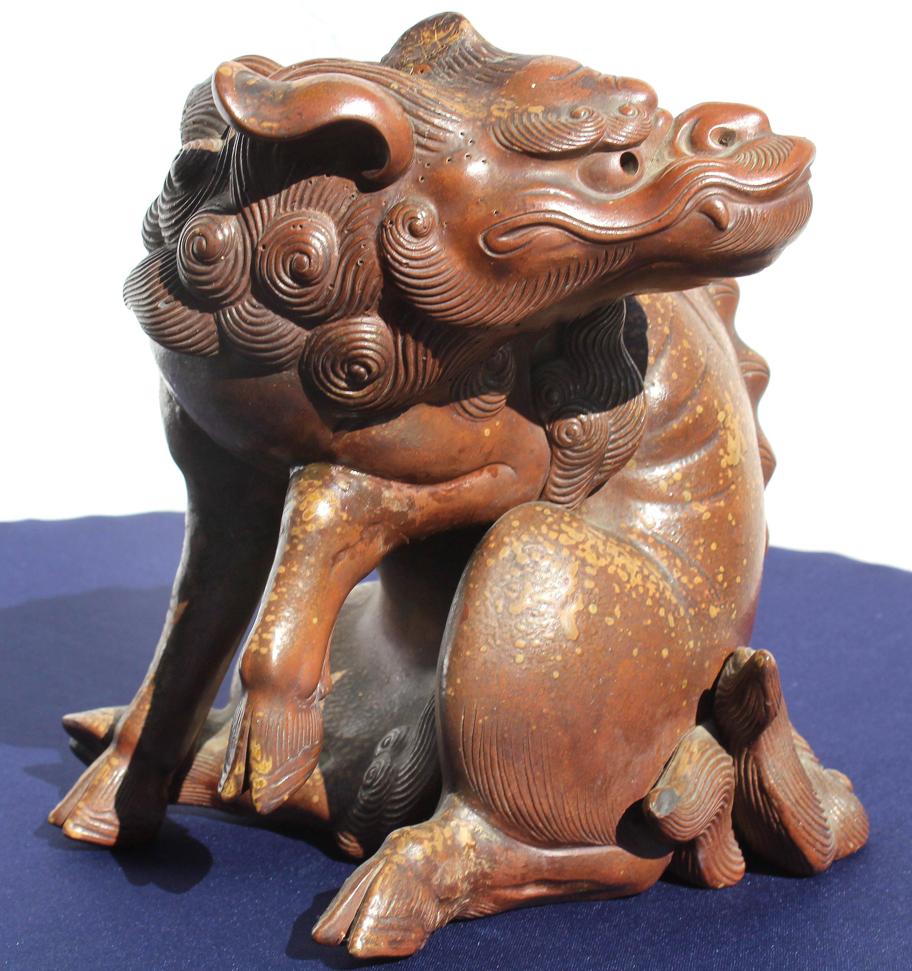 19th Century Japanese Earthenware Foo Dog Lion Dragon

Offered for sale is a dramatic and strong late 19th century Japanese foo lion. The earthenware figure was created in an unusual form and was acquired from a New York City dealer's private Asian