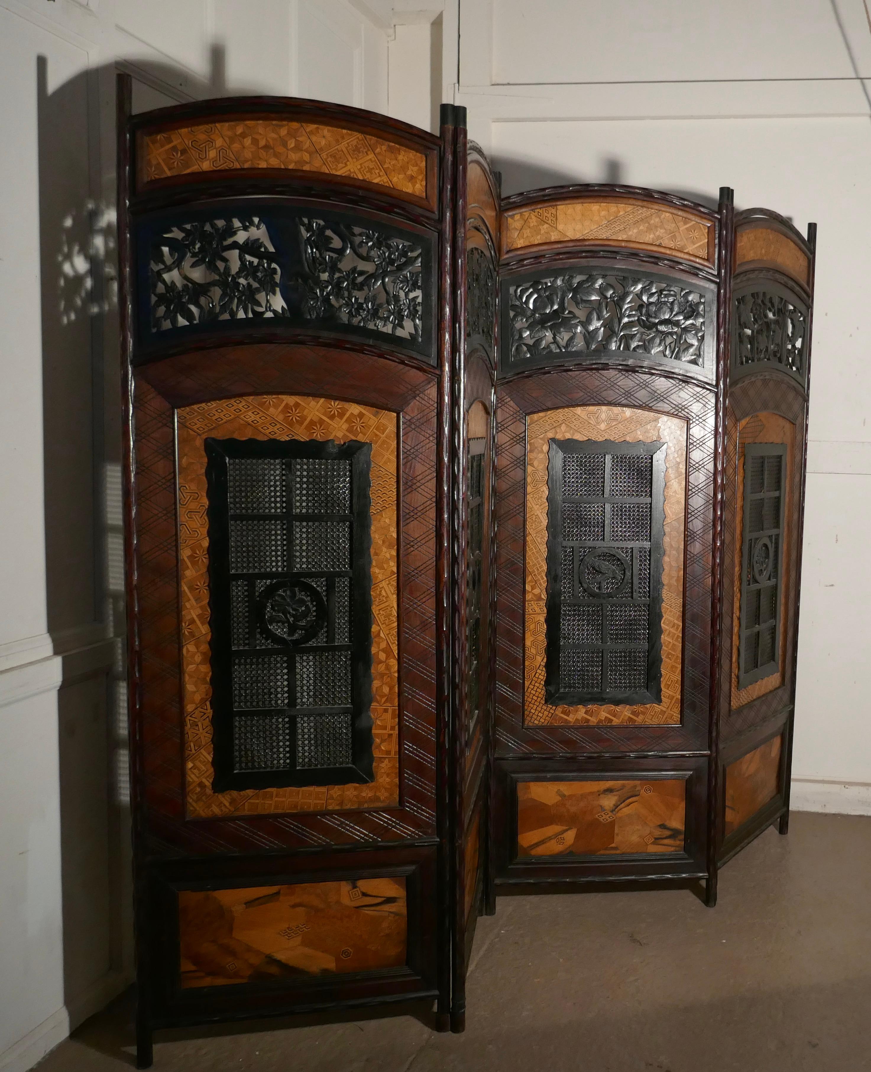 19th century Japanese Folk Art 4 fold screen, room divider

This is a heavy piece, the screen is made from many hard woods, in filigree carving, patchwork marquetry and woven flat cane
All the panels are slightly different, each panel has an