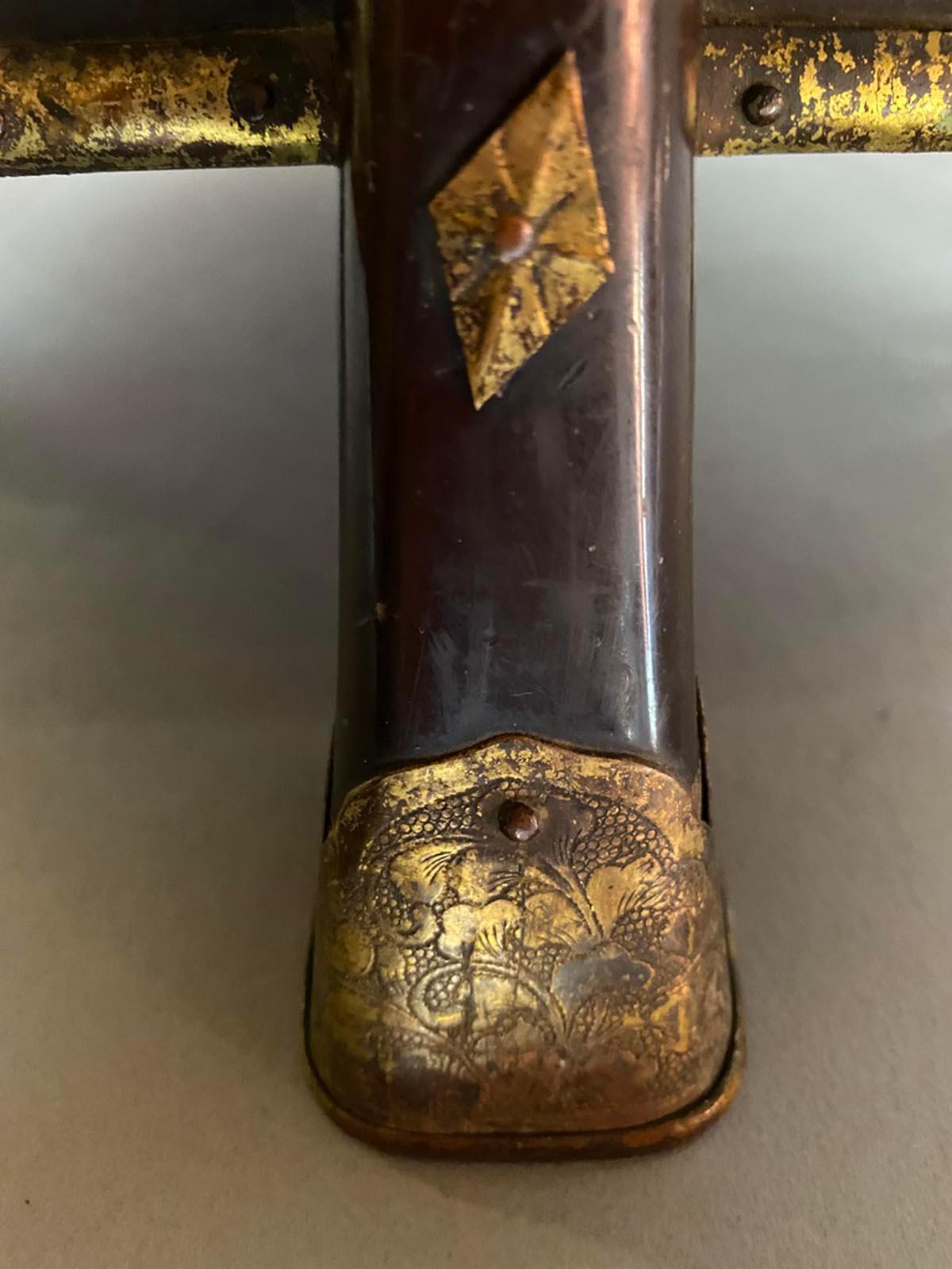 Edo period Hokkai, lacquered and painted box. Beautifully painted gold flowers painted o lacquer. Rope can be removed. Brass over copper intricately hammered details on feet and throughout box. Can be used as a small side table and for storage.