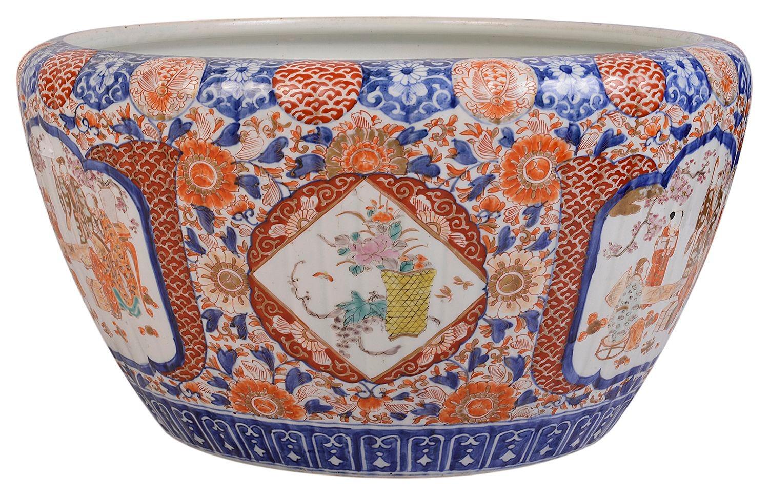 A good quality late 19th Century Japanese Imari jardiniere, having wonderful bold classical blue and orange Imari colours depicting motif and floral boarders with hand painted inset panels of scholars in discussion. 
 
Batch 72 